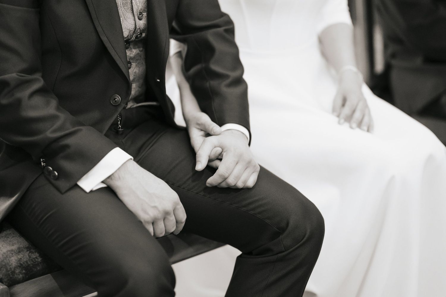 Black and white wedding reception dance floor scene with couples dancing in formal attire.