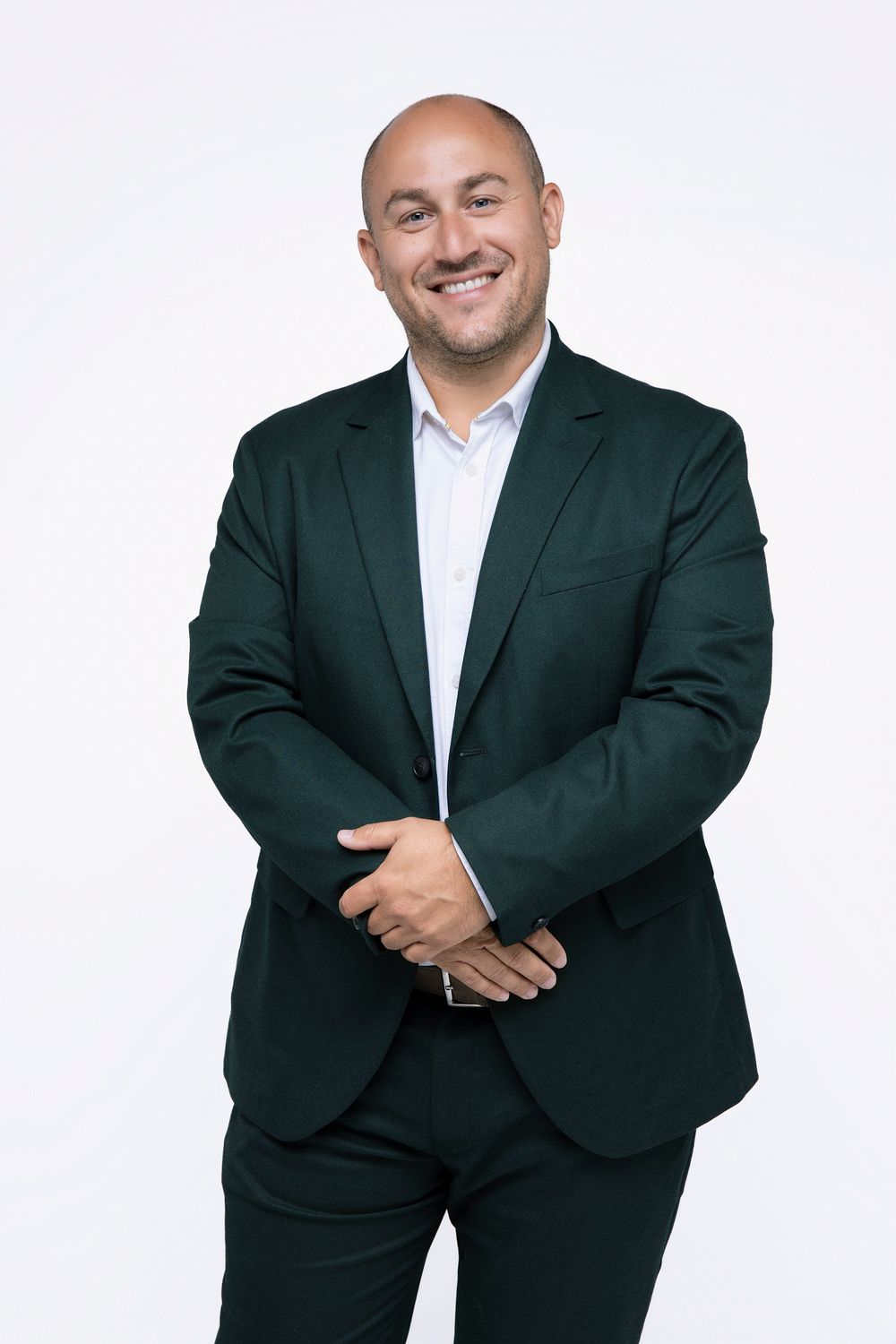 Professional businessman in dark suit and white shirt poses in four different casual stances against white background.
