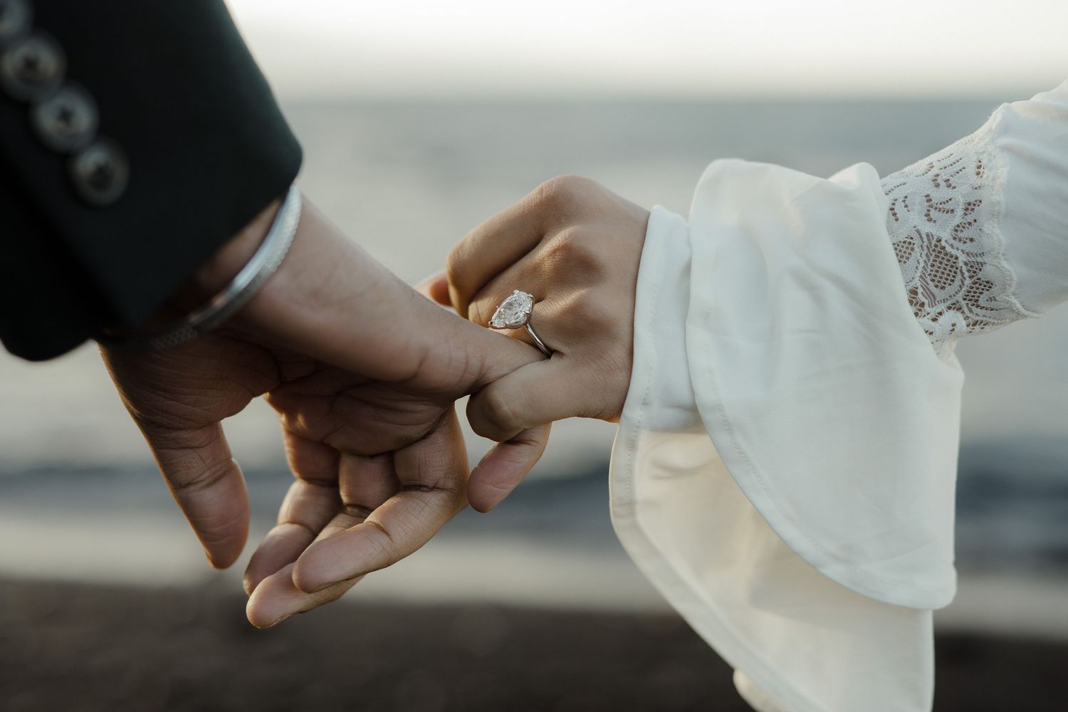 A sequence of hands exchanging wedding rings during a ceremony against a blurred background.