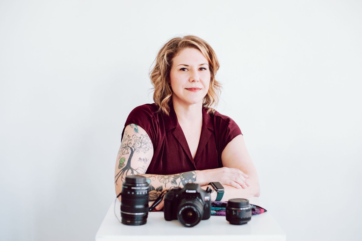 Professional camera setup with multiple lenses displayed on white background.