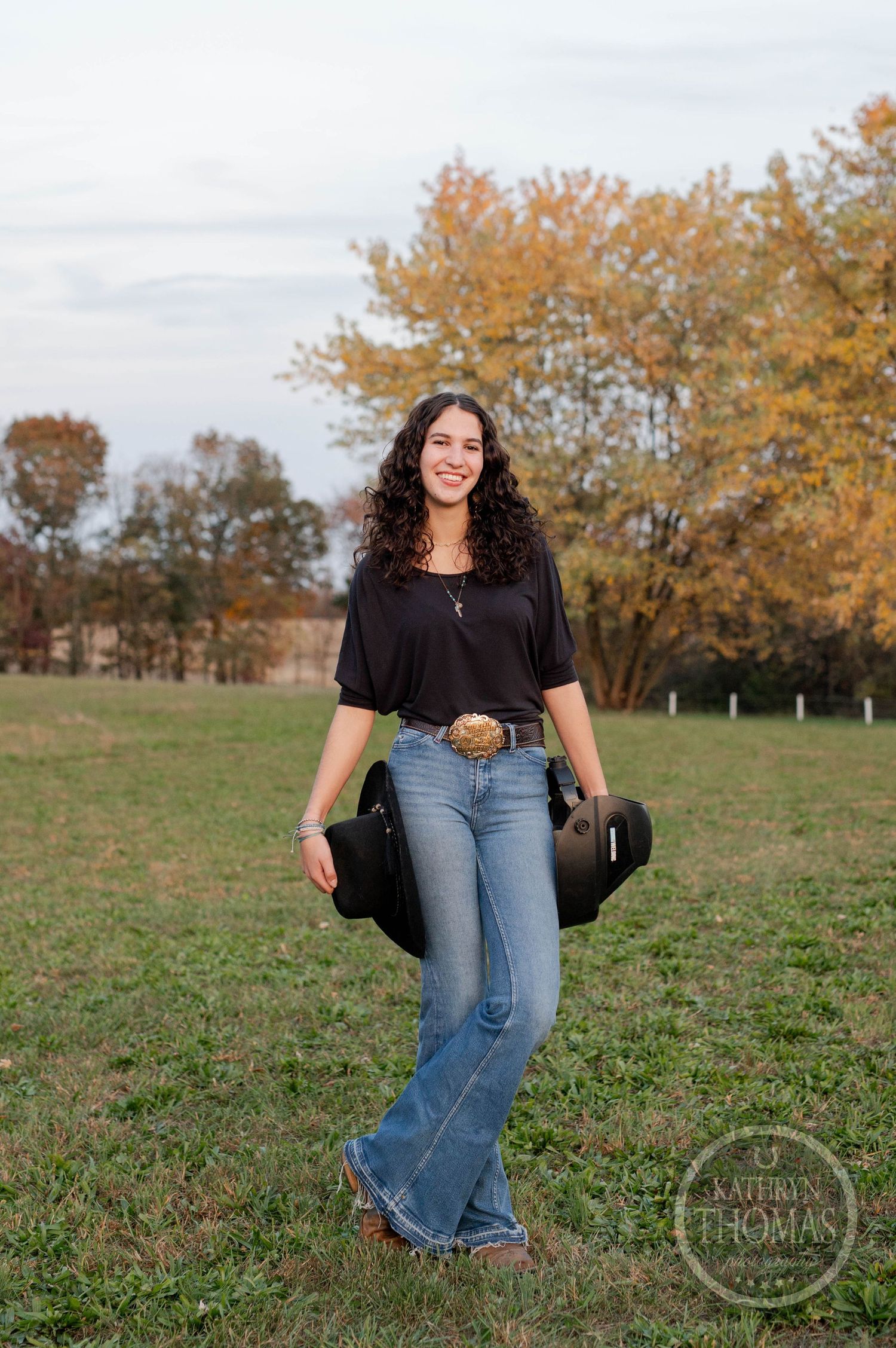 Autumn outdoor portrait with fall foliage and trees in the background on a sunny day.