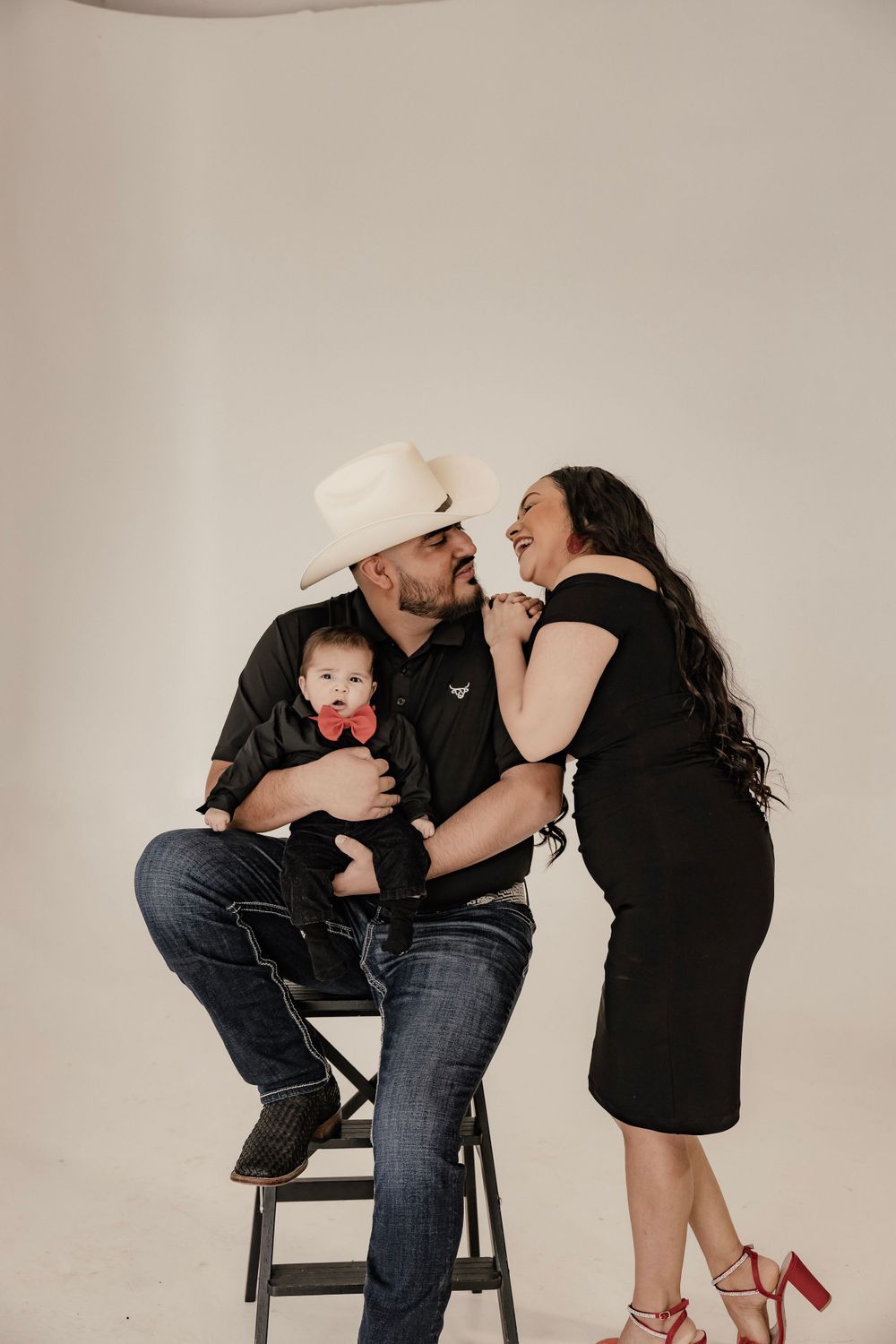 Mom, dad and baby posing for a family photo