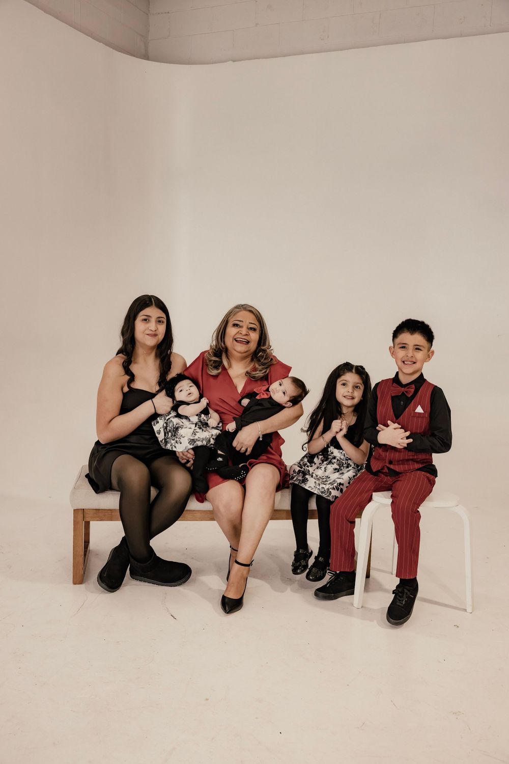 Two adults, two children, two babies posing for a family photo