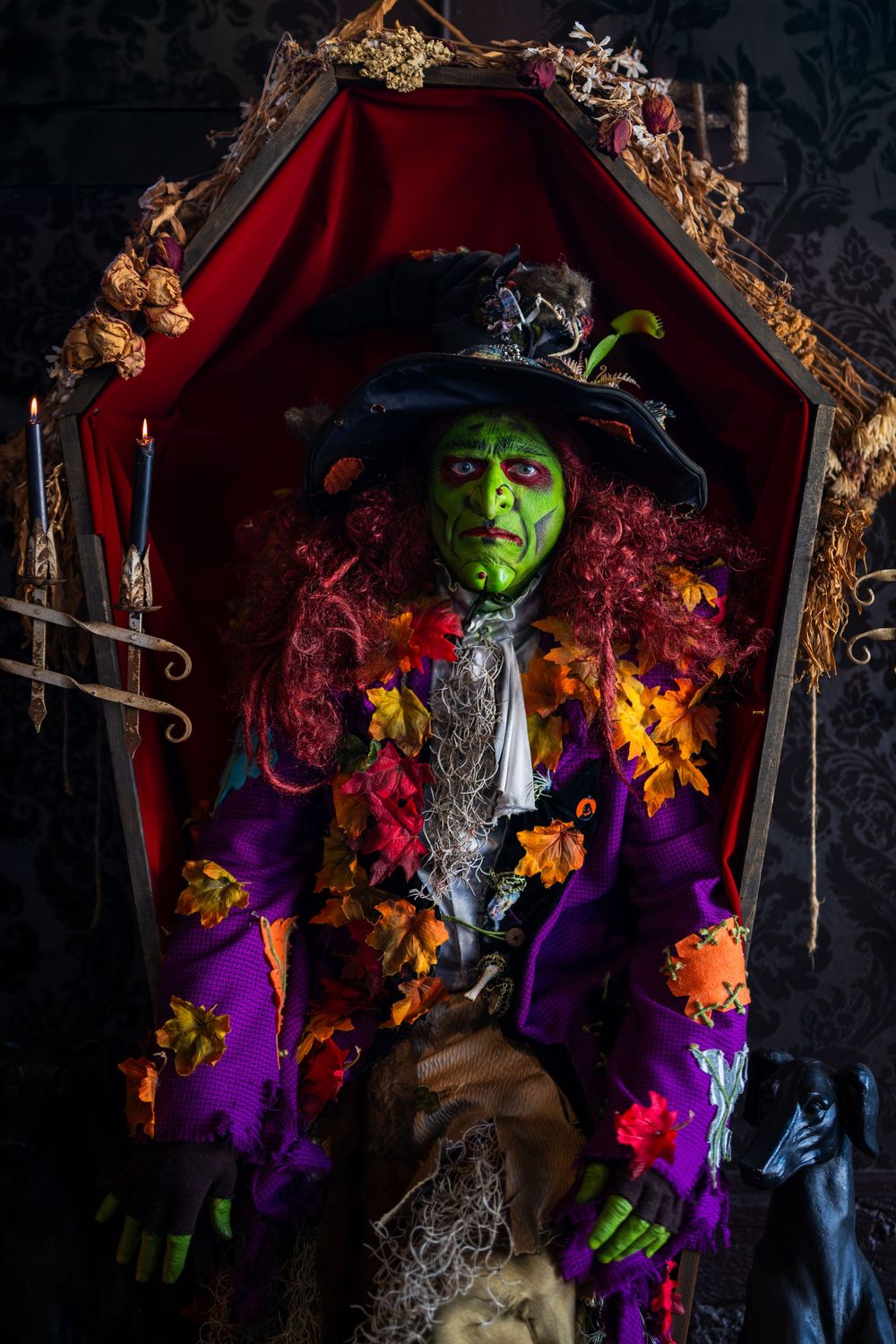 Haunting witch figure displayed in ornate red-lined frame with gothic decorative elements.