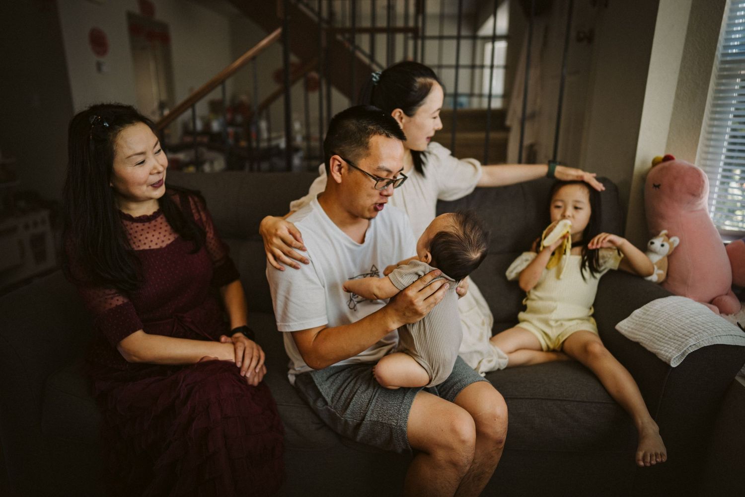 A group of people on a couch enjoying a fun and lively conversation moment together.