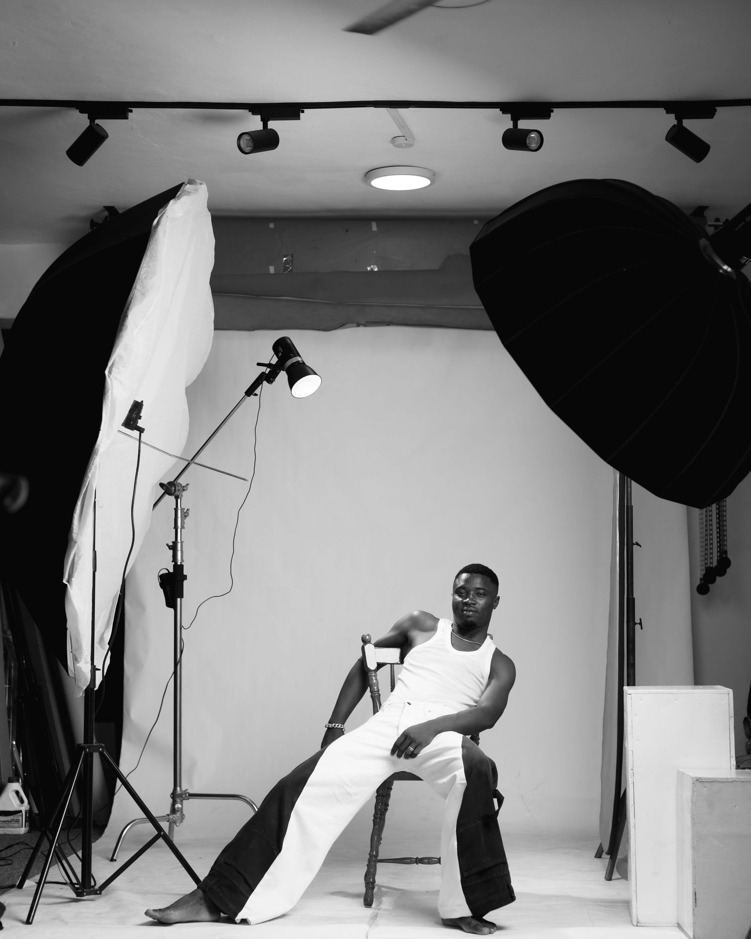 Professional photo studio setup with lighting equipment and white backdrop.
