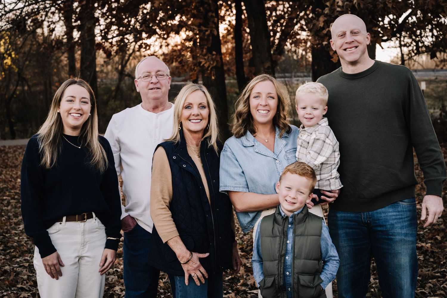 extended family stand together outdoors during golden hour for a casual family photo session. Family photographer in Middle Tennessee captur