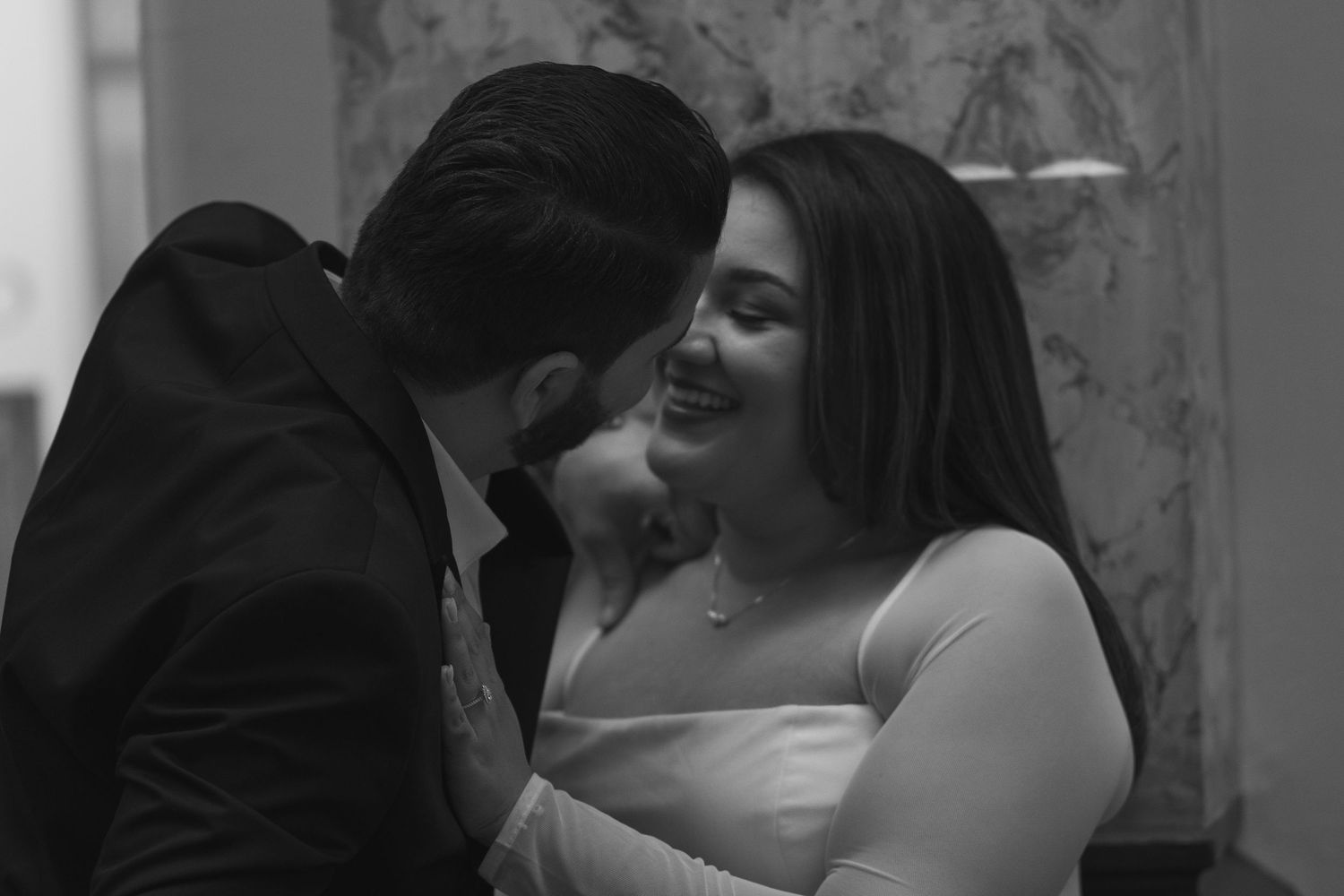 Black and white photo of people dancing together at a party or celebration.