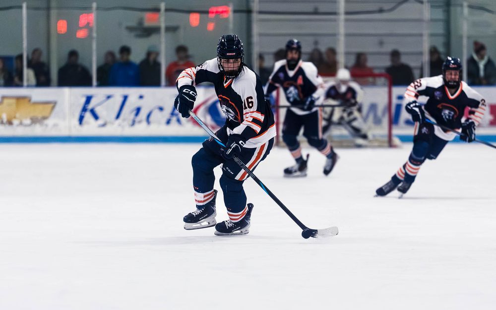 Trojans players skate up the ice in formation during the Bears Cup Semifinal by SportsFox Photography, Hershey PA.