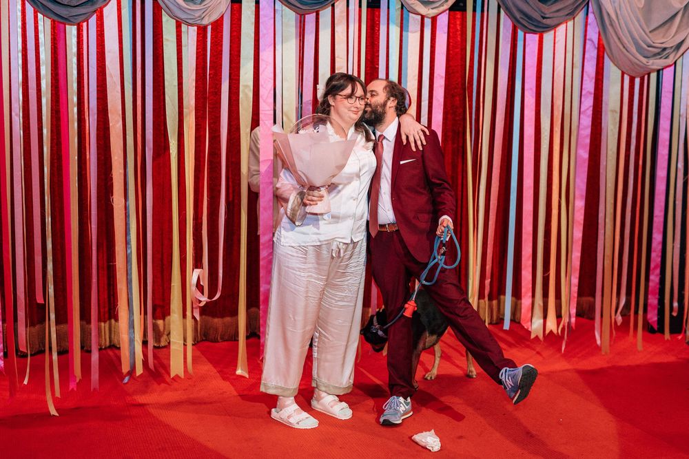 Bride and groom kiss at wedding ceremony on Bob Baker stage