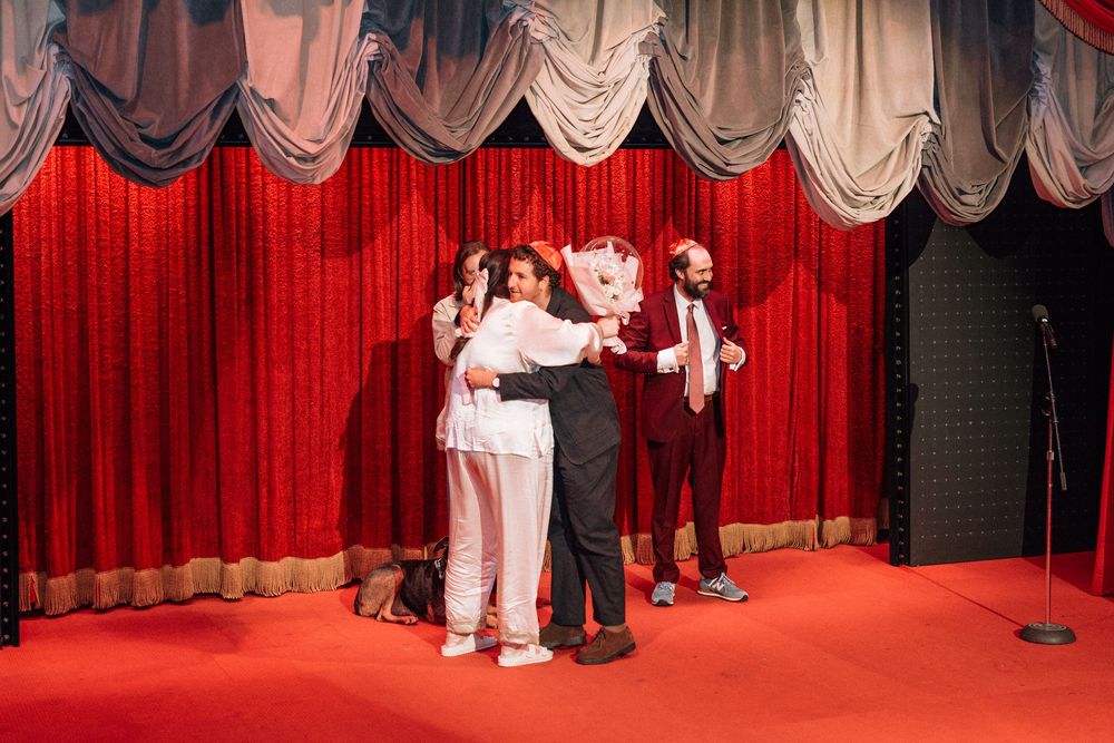 Couple hugs their guests at Bob Baker Theater before their wedding vows