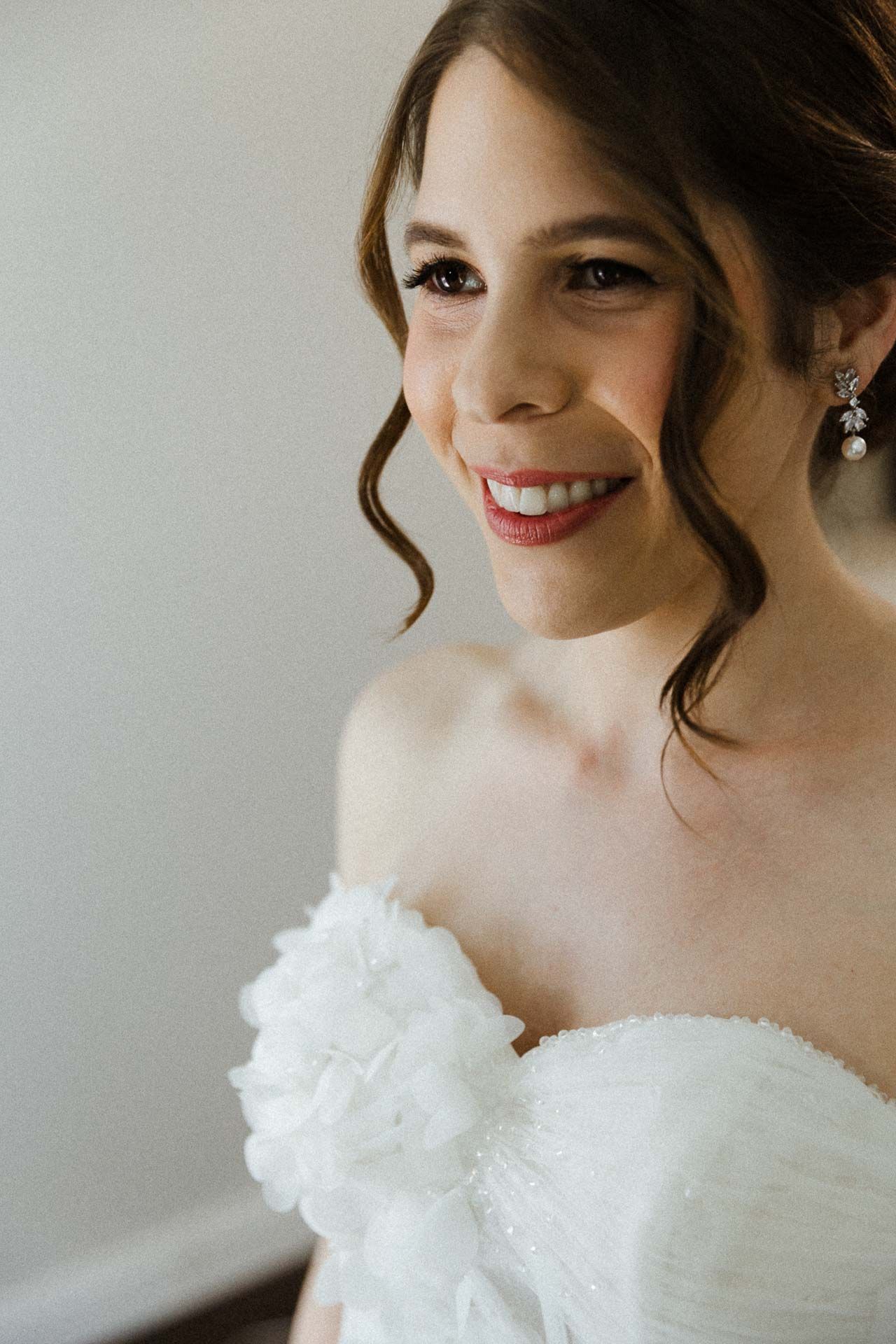 Close-up shots of a bride wearing a classic white wedding gown with delicate off-shoulder details.
