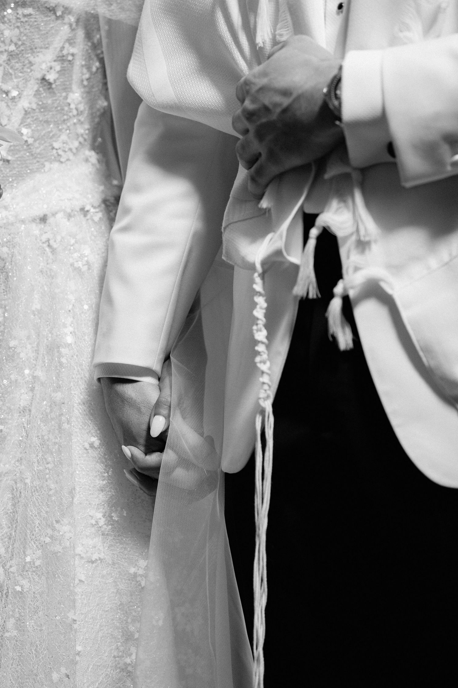 A series of cropped black and white images showing parts of a wedding dress and formal attire.
