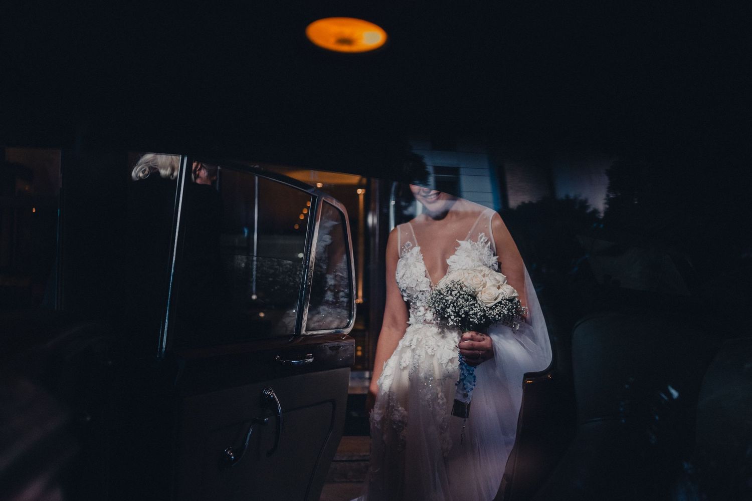 Dark and moody wedding reception venue with warm ambient lighting creating dramatic atmosphere.