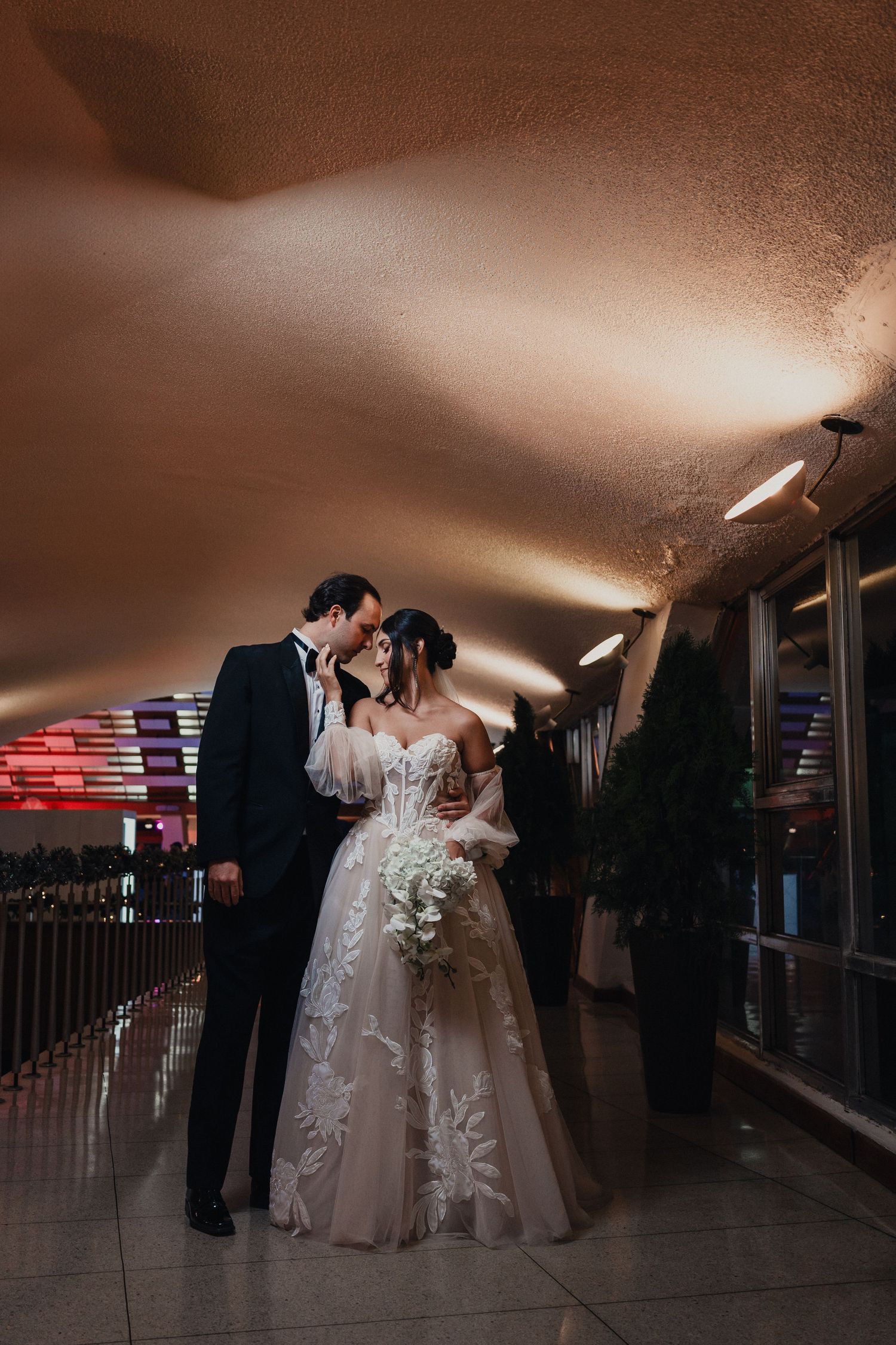 A dramatic silhouetted wedding dance sequence in a dimly lit ballroom setting.