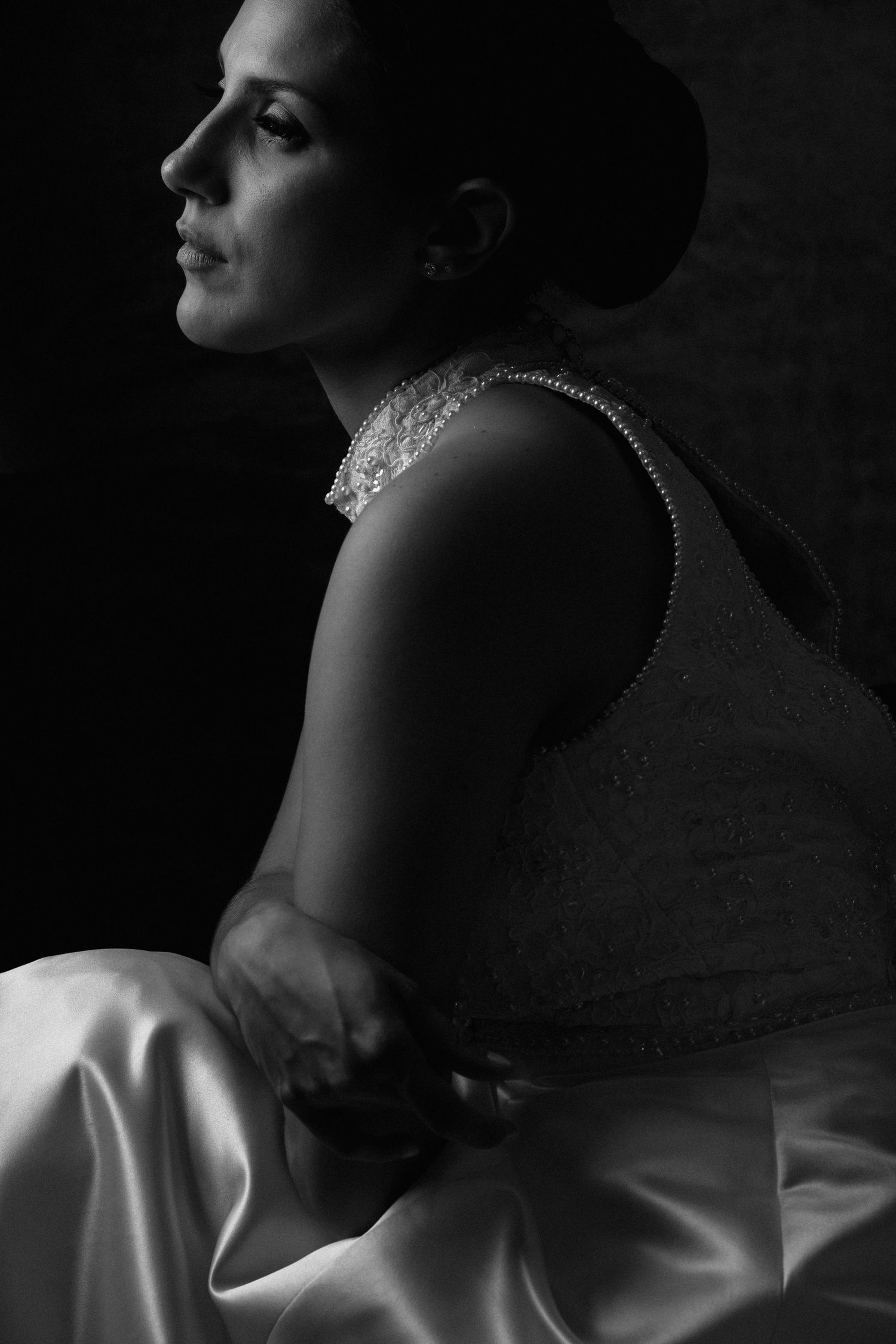 Dramatic black and white portrait series showing elegant profile poses with soft lighting and shadows.