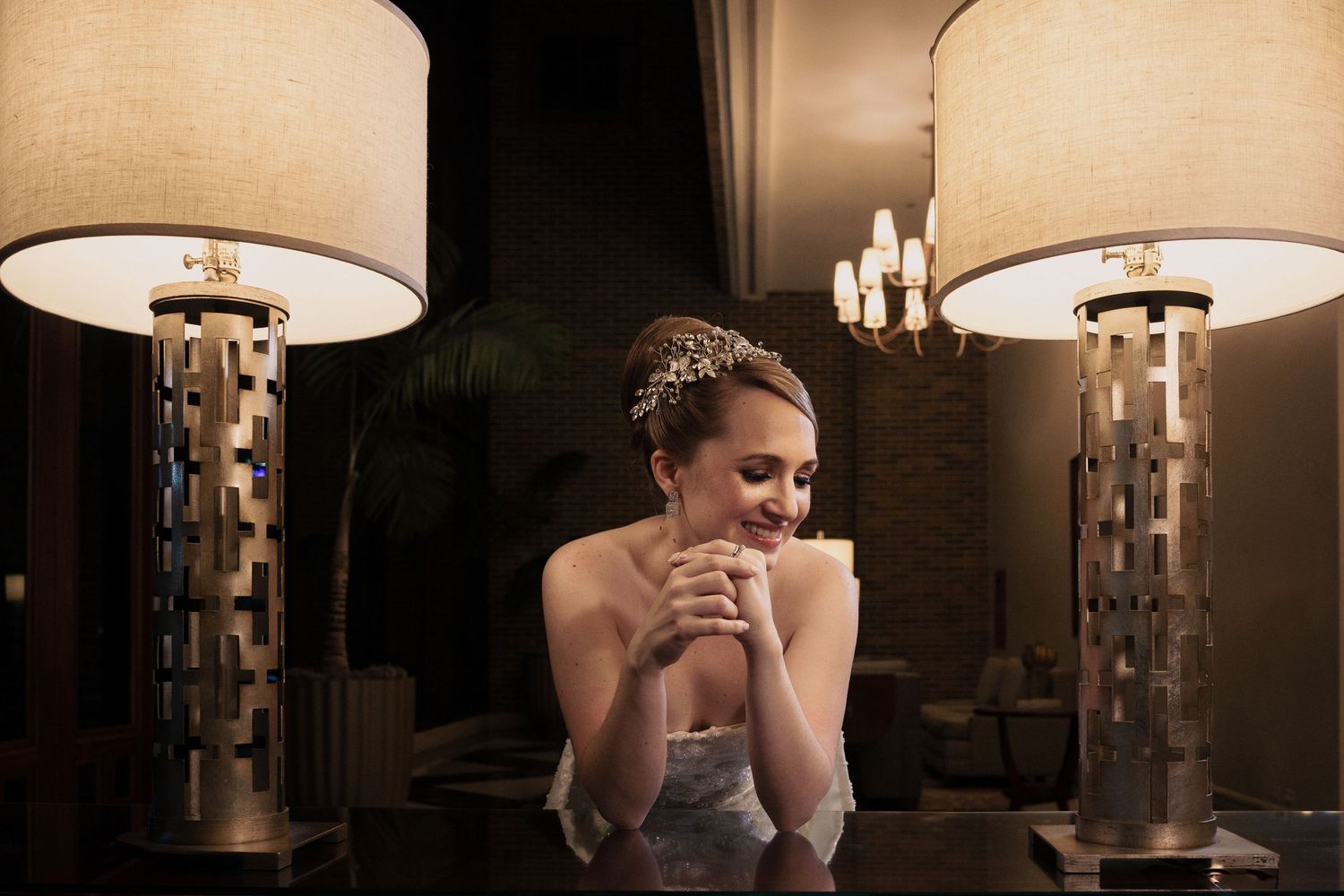 A series of six photos showing someone sitting in a dimly lit room with decorative wall sconces and lampshades.
