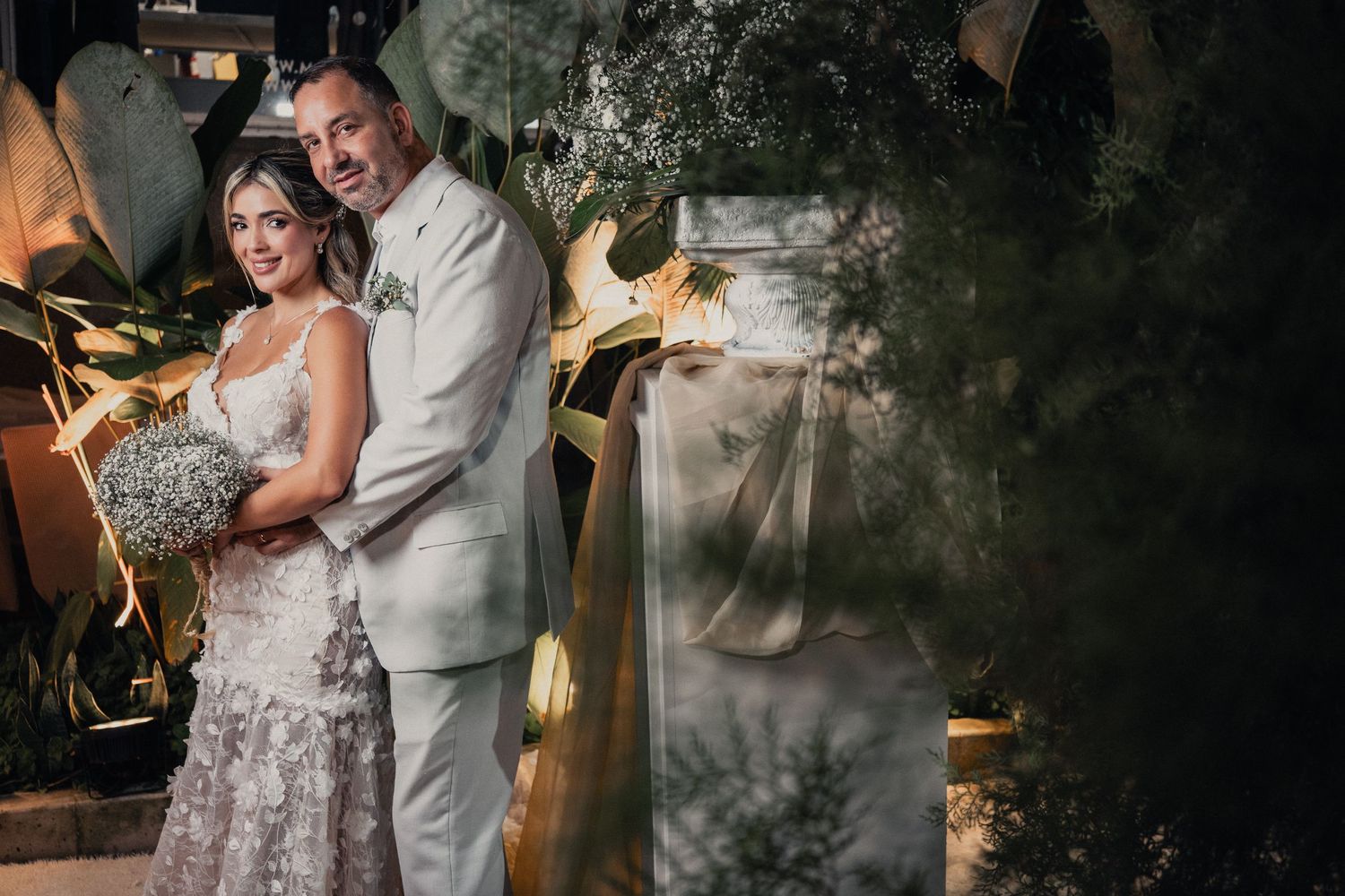 Couple dancing in an intimate setting with atmospheric lighting and smoke effects.