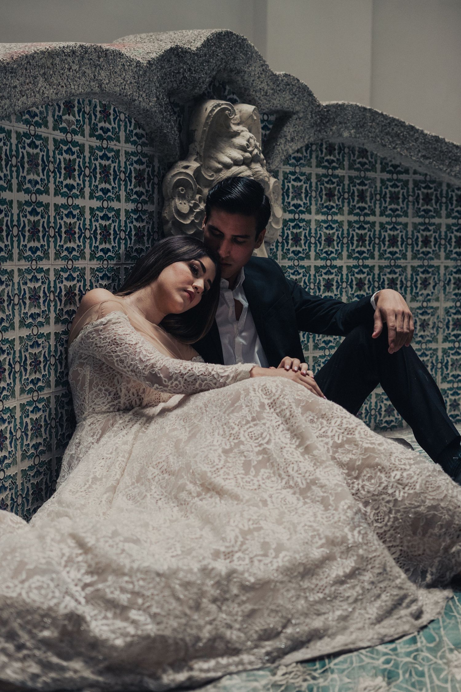 A romantic wedding photo sequence showing a couple laying on patterned tiles in elegant formal attire.