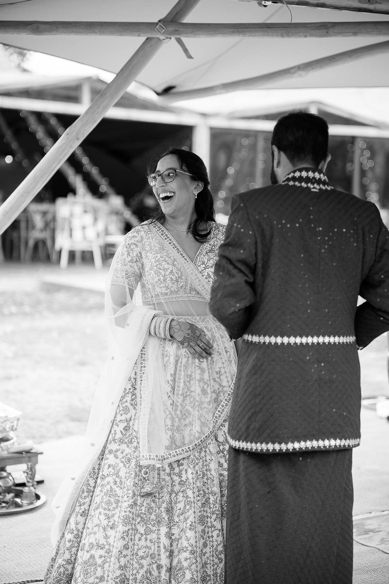 A sequence of black and white wedding photos showing a couple dancing and laughing together at an outdoor reception  at mapledurham house