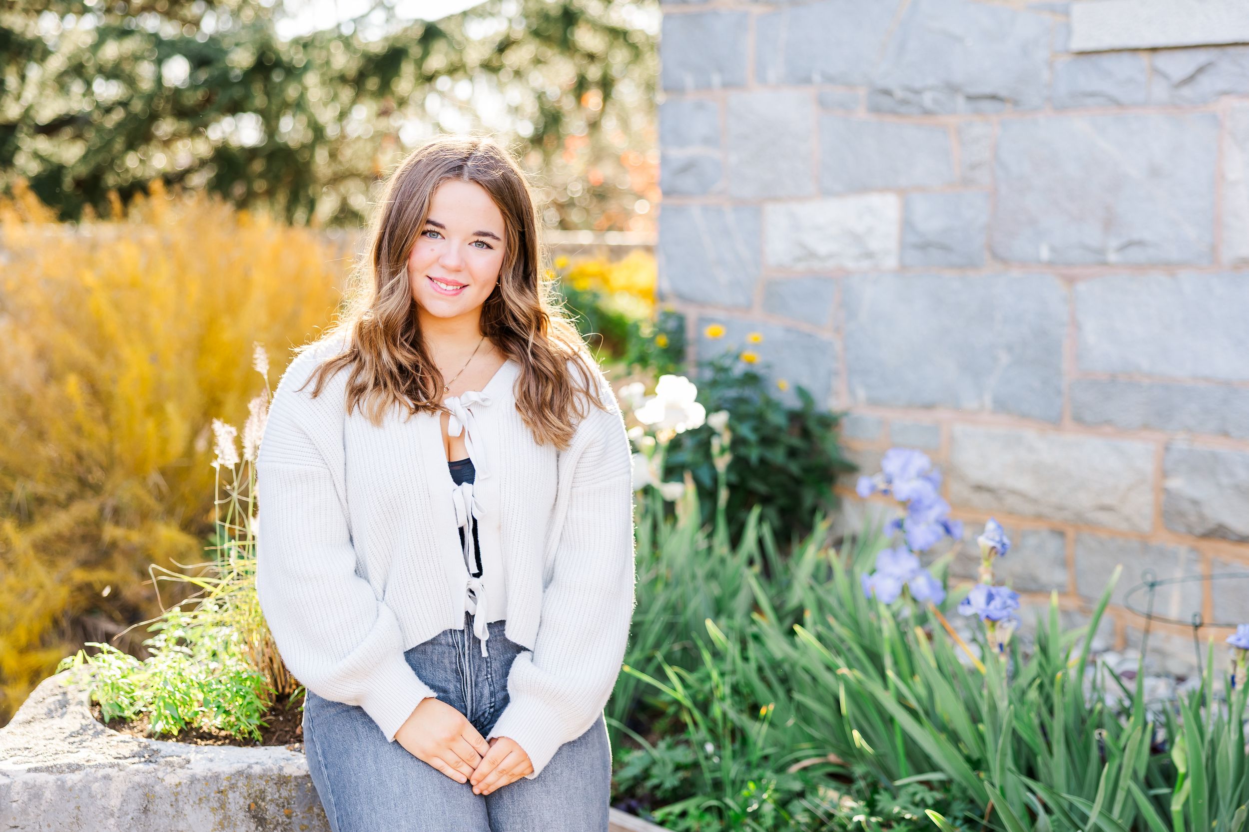 A series of outdoor portrait photos taken in autumn with stone walls and golden foliage in the background at Maymont Park in Richmond, VA