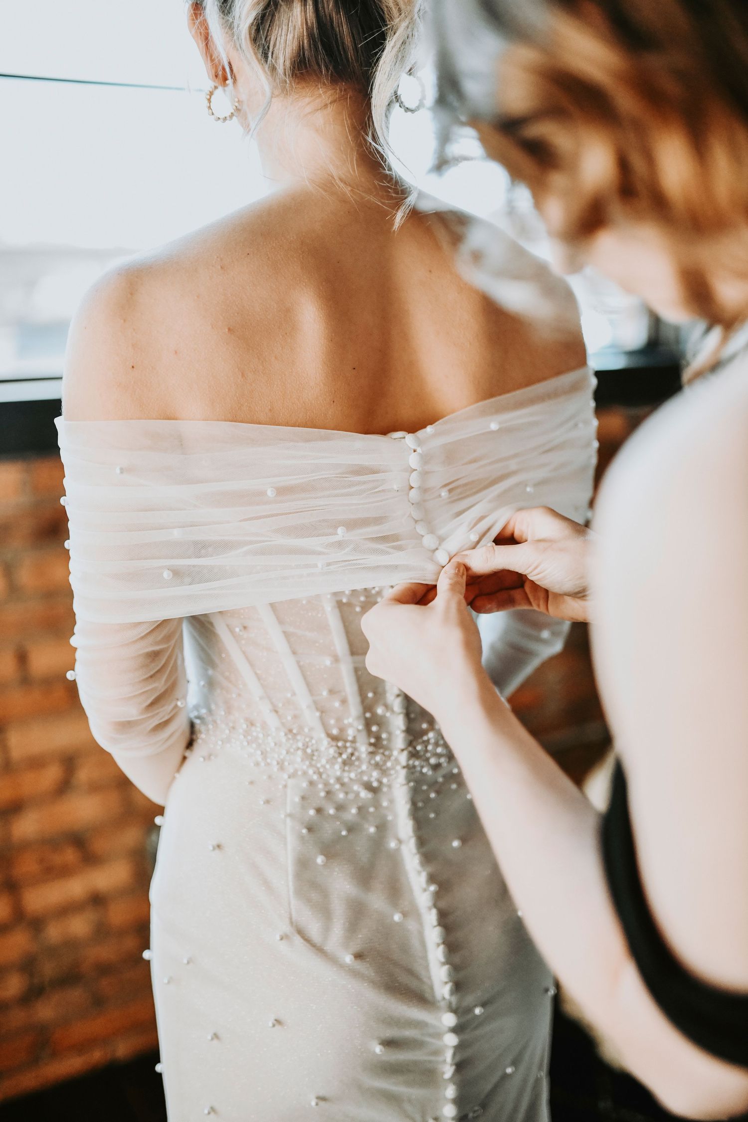 Close-up of bride’s gown details and tailoring