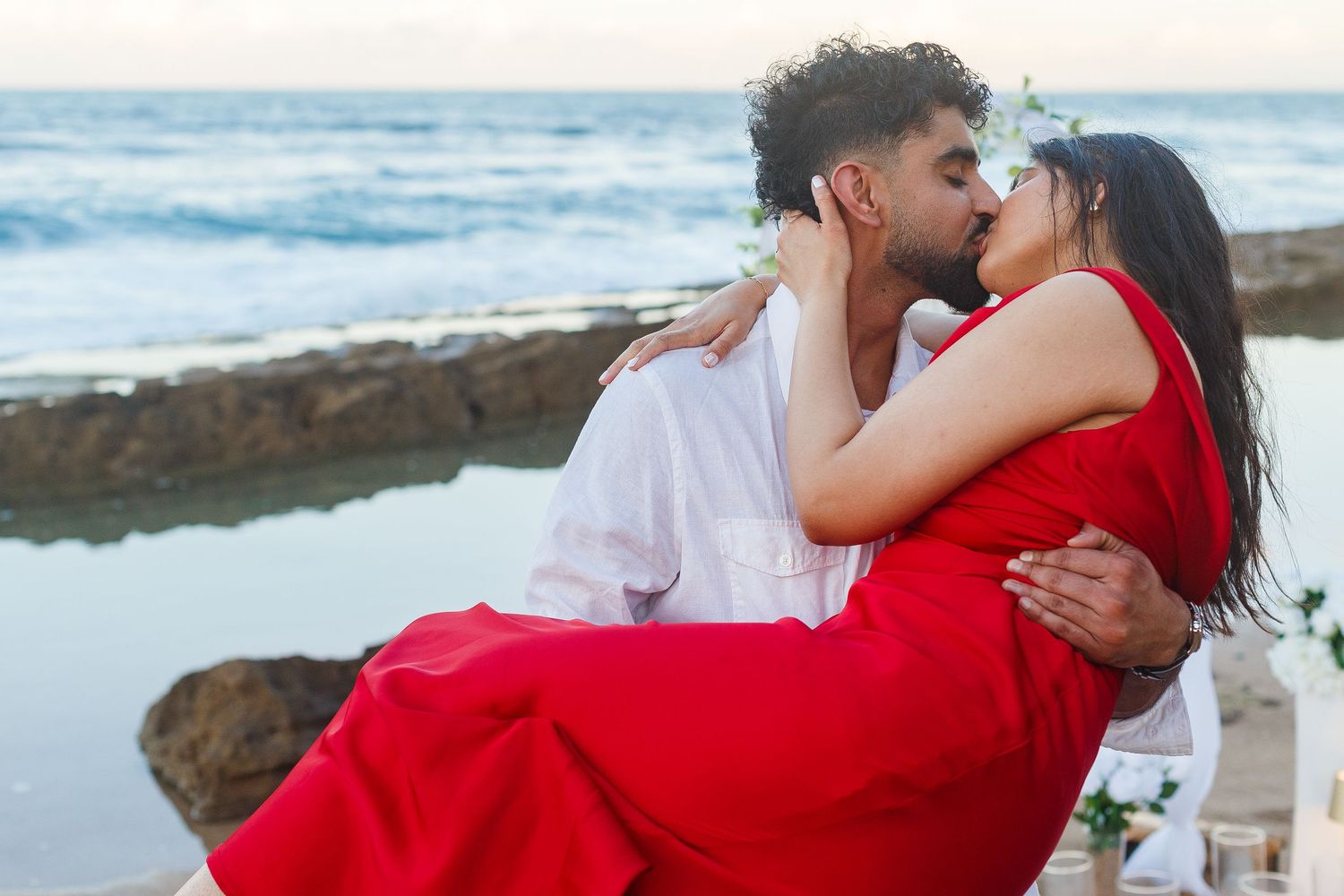 Couples portrait. Proposal and engagement session. Man and woman on the beach. Man carrying woman. Kikita Surf Beach, Dorado, Puerto Rico.