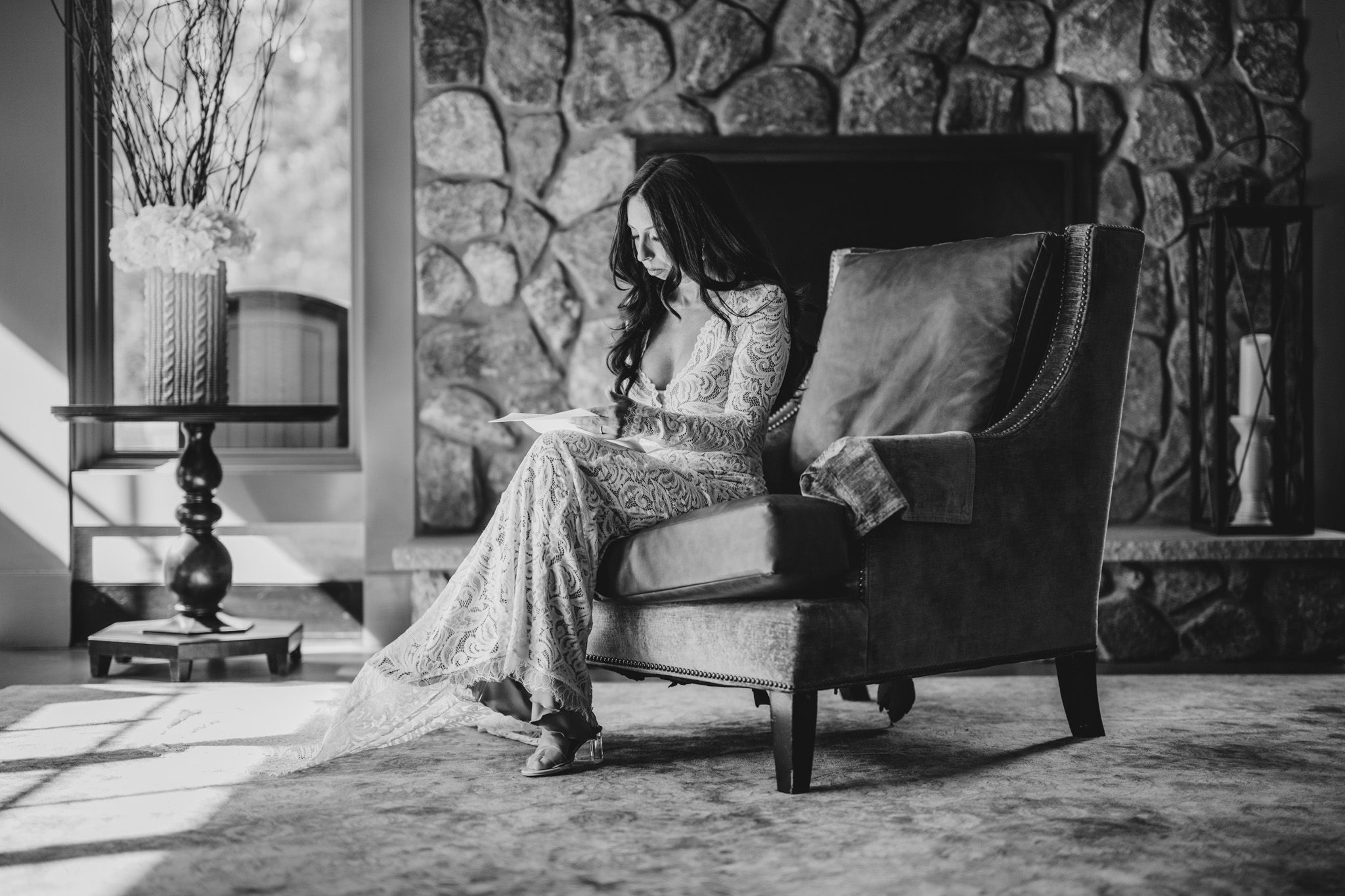 Black and white wedding photography series showing elegant poses against stone walls.