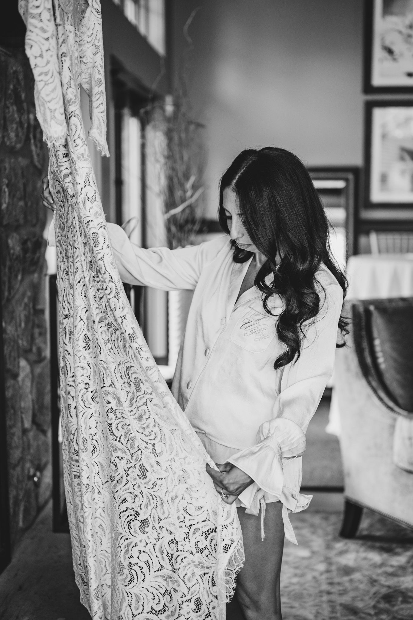 Elegant lace wedding dress details photographed in black and white.