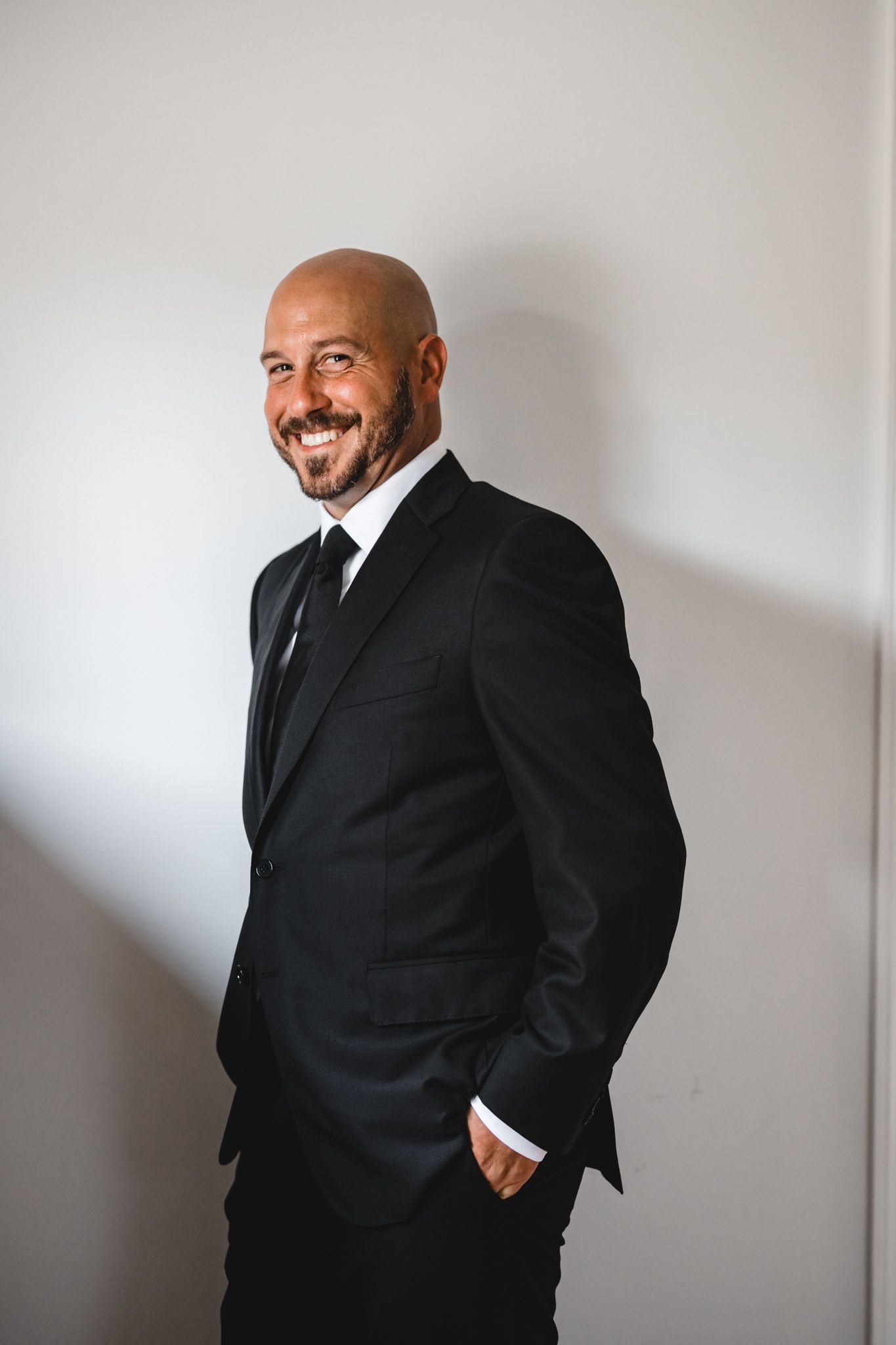 Candid black and white portraits showing joyful expressions in formal wear.