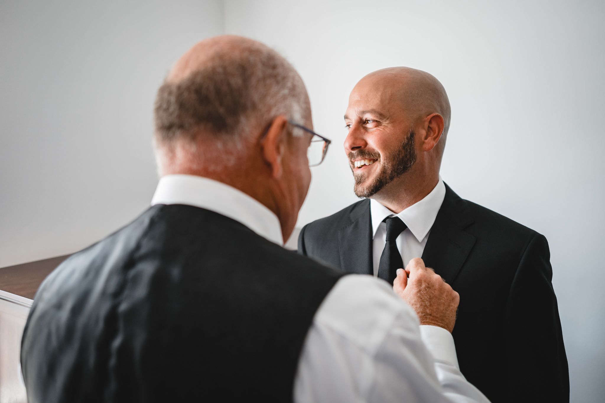 Candid black and white shots of people getting ready for a formal occasion.
