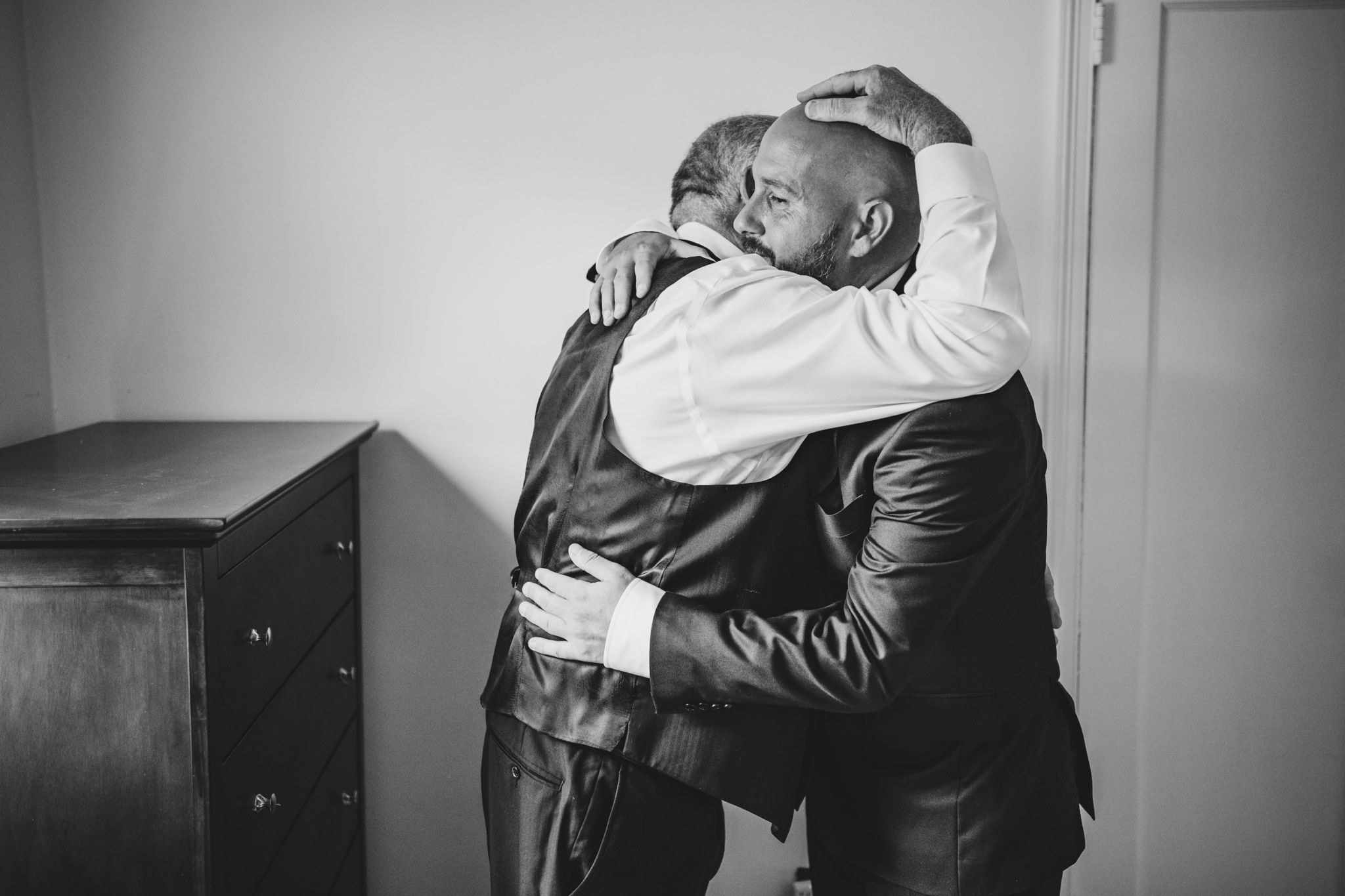 Emotional black and white moments captured during wedding preparations.