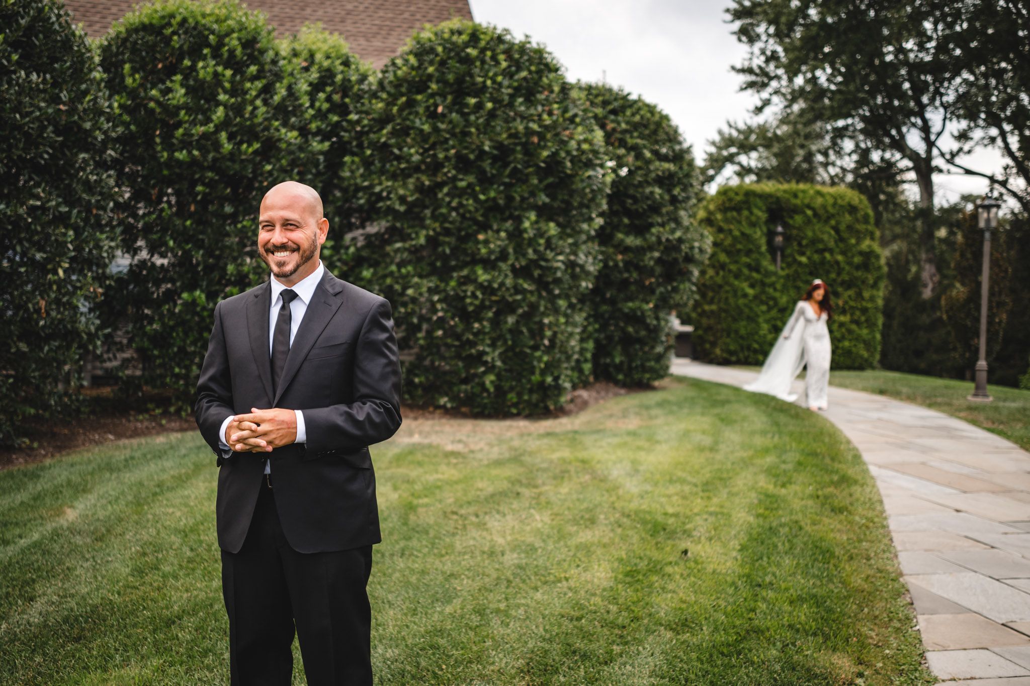 Formal portraits taken outdoors with lush green landscaping and pathway.