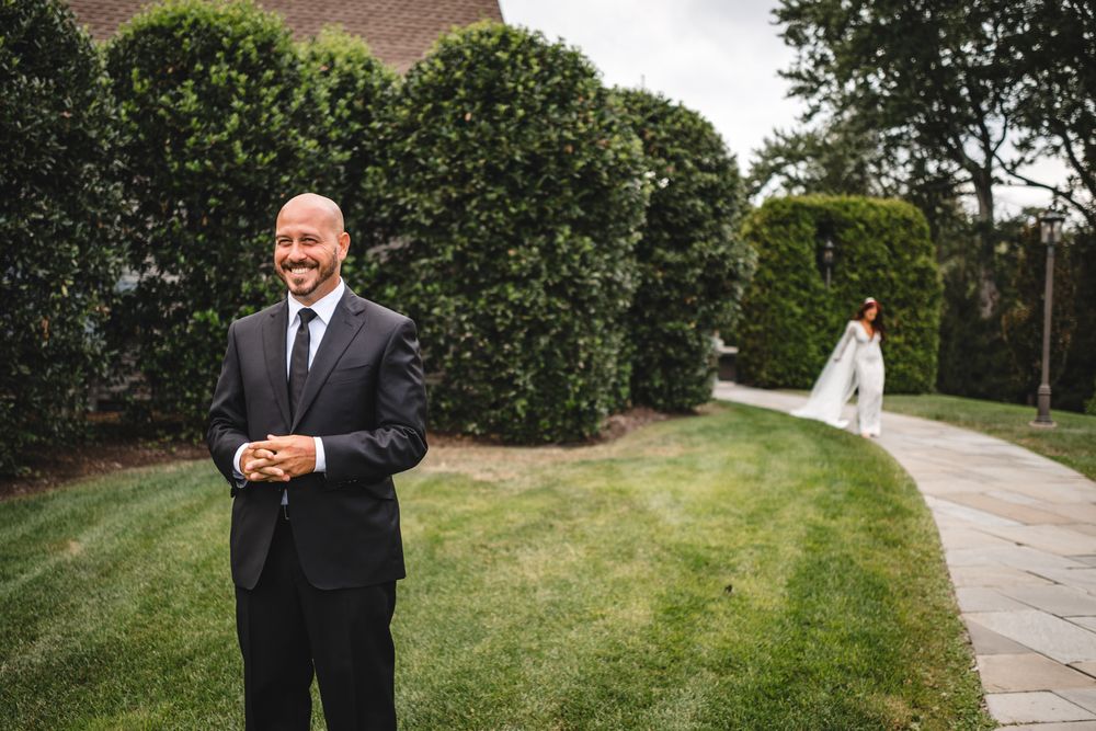 Formal portraits taken outdoors with lush green landscaping and pathway.