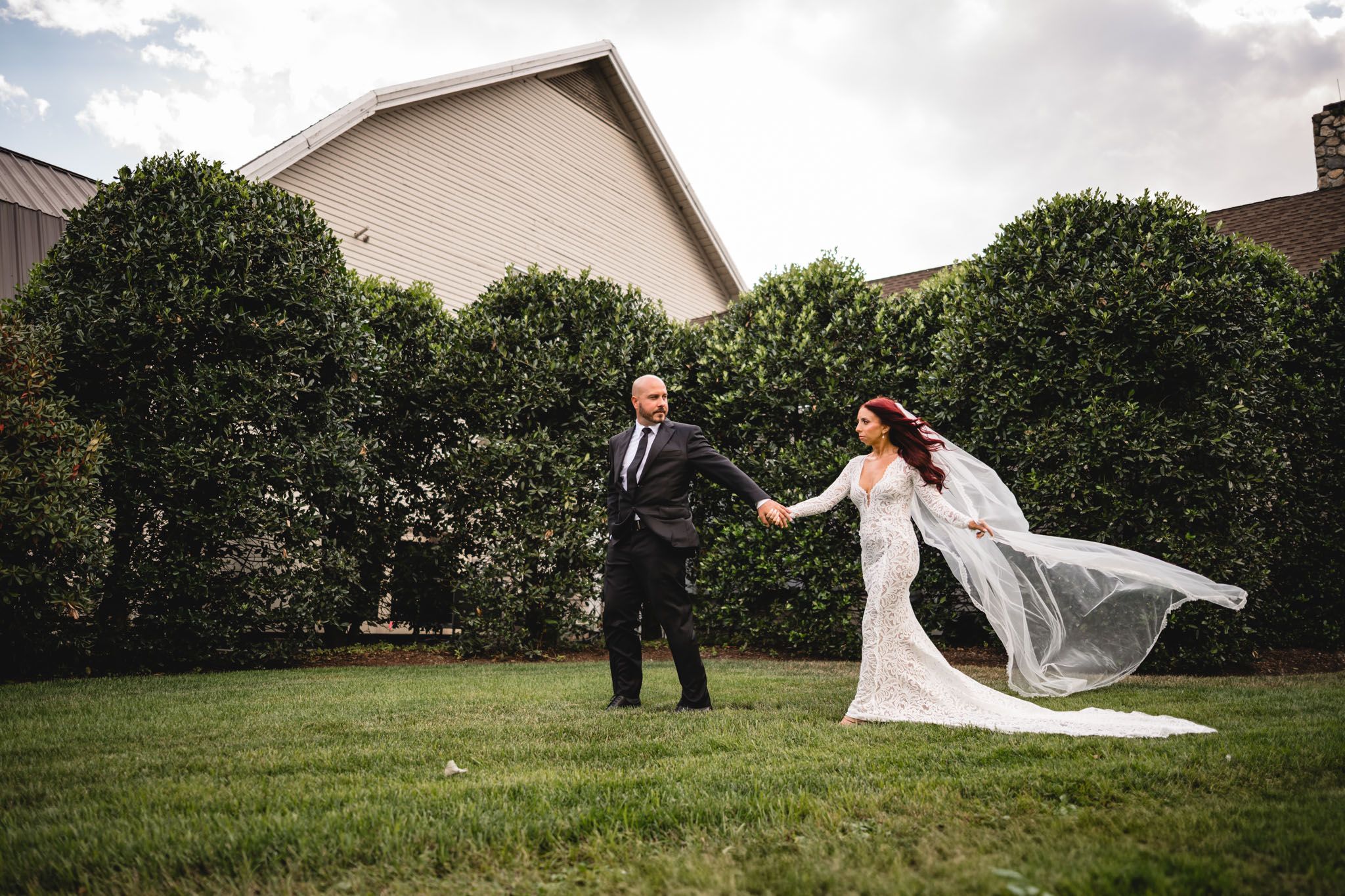 A bride and groom share intimate moments during their outdoor wedding photoshoot.