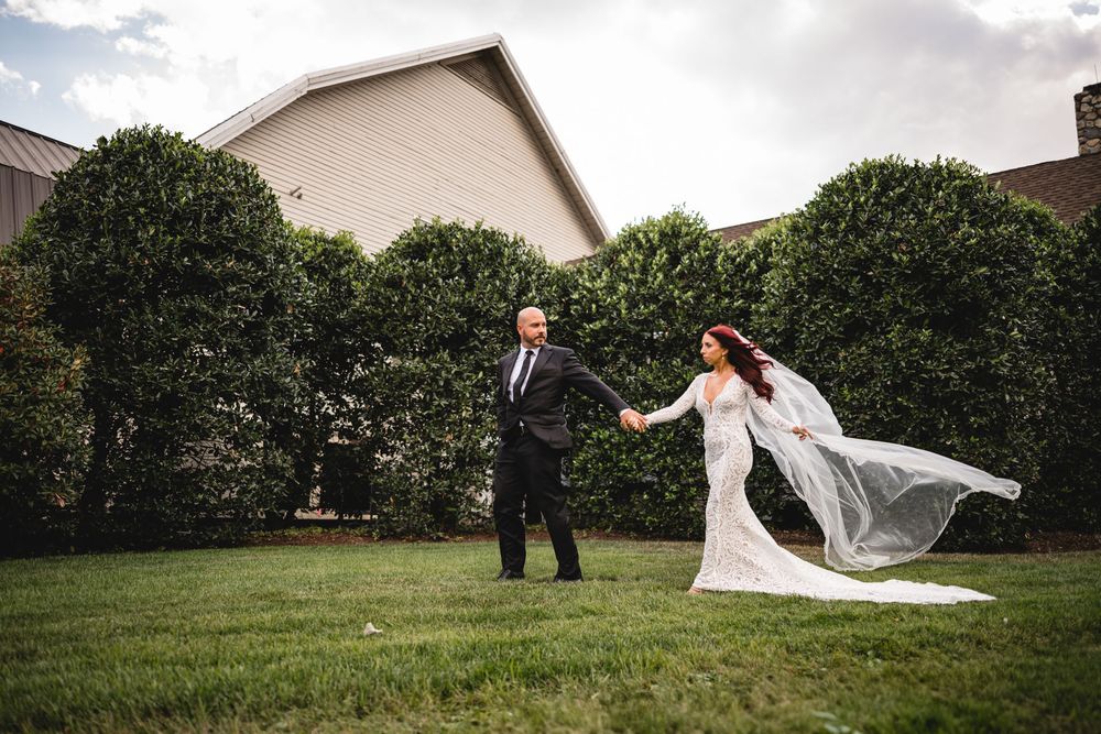 A bride and groom share intimate moments during their outdoor wedding photoshoot.