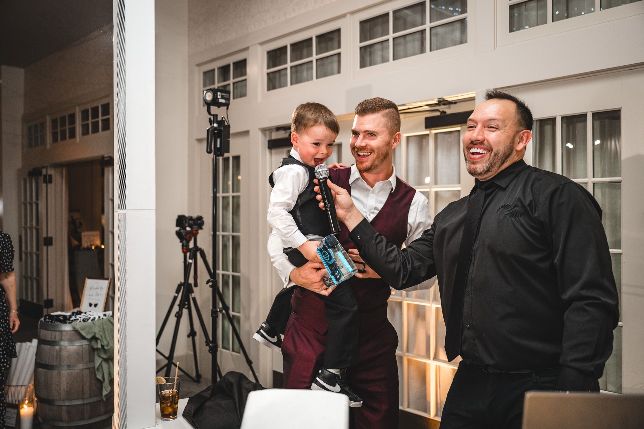 Wedding guests enjoying candid moments during evening reception festivities.