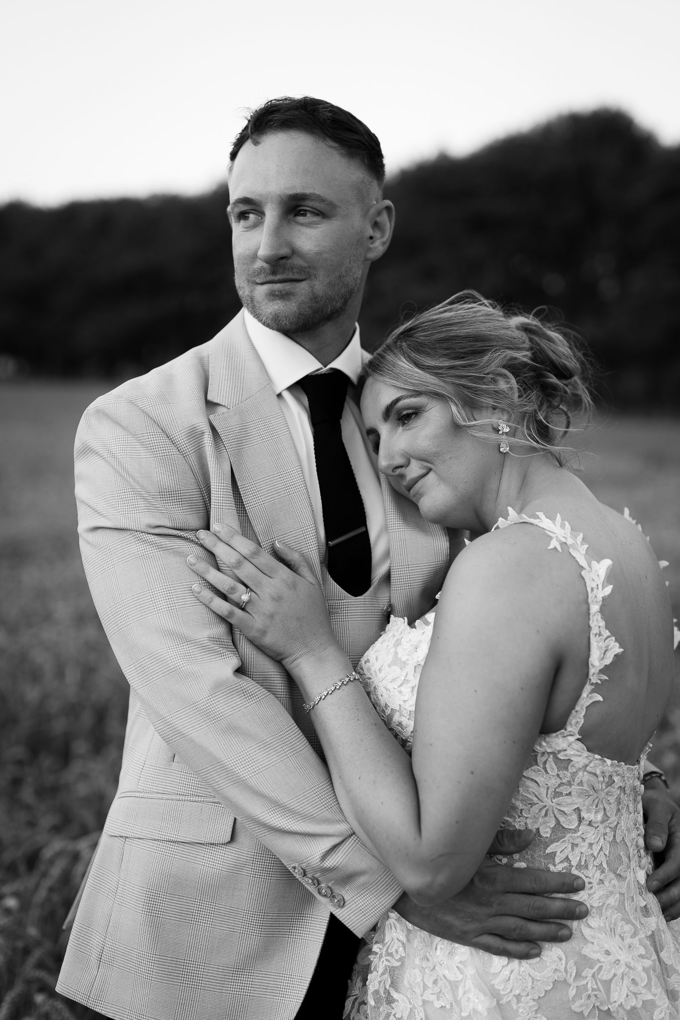 A romantic black and white wedding photo sequence shows a couple embracing in a field.