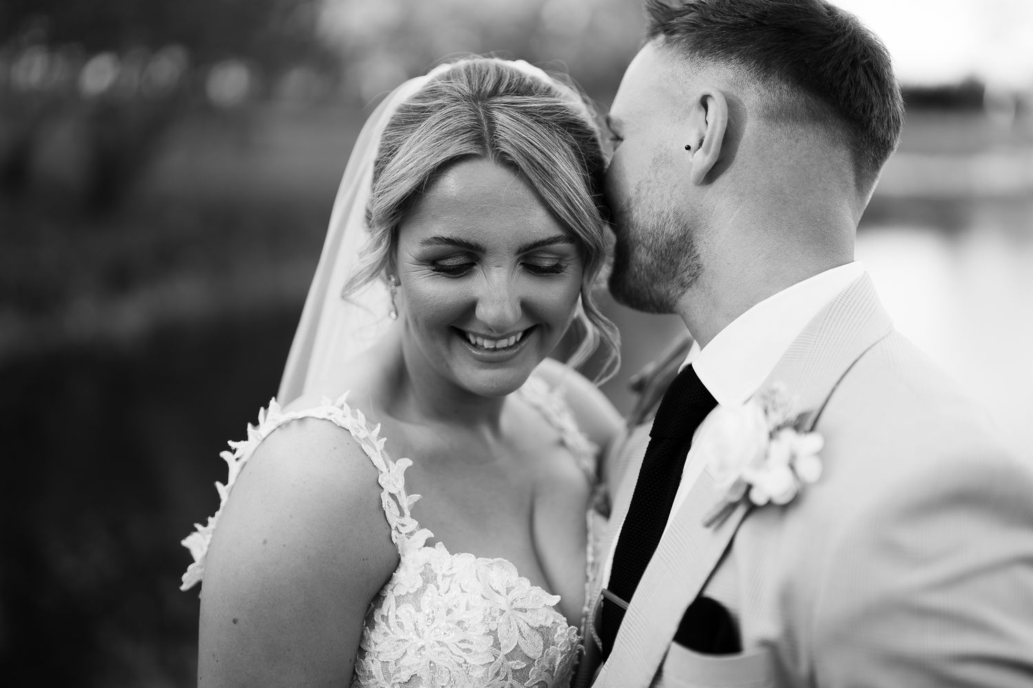 A bride and groom share intimate moments in a series of black and white wedding photographs.