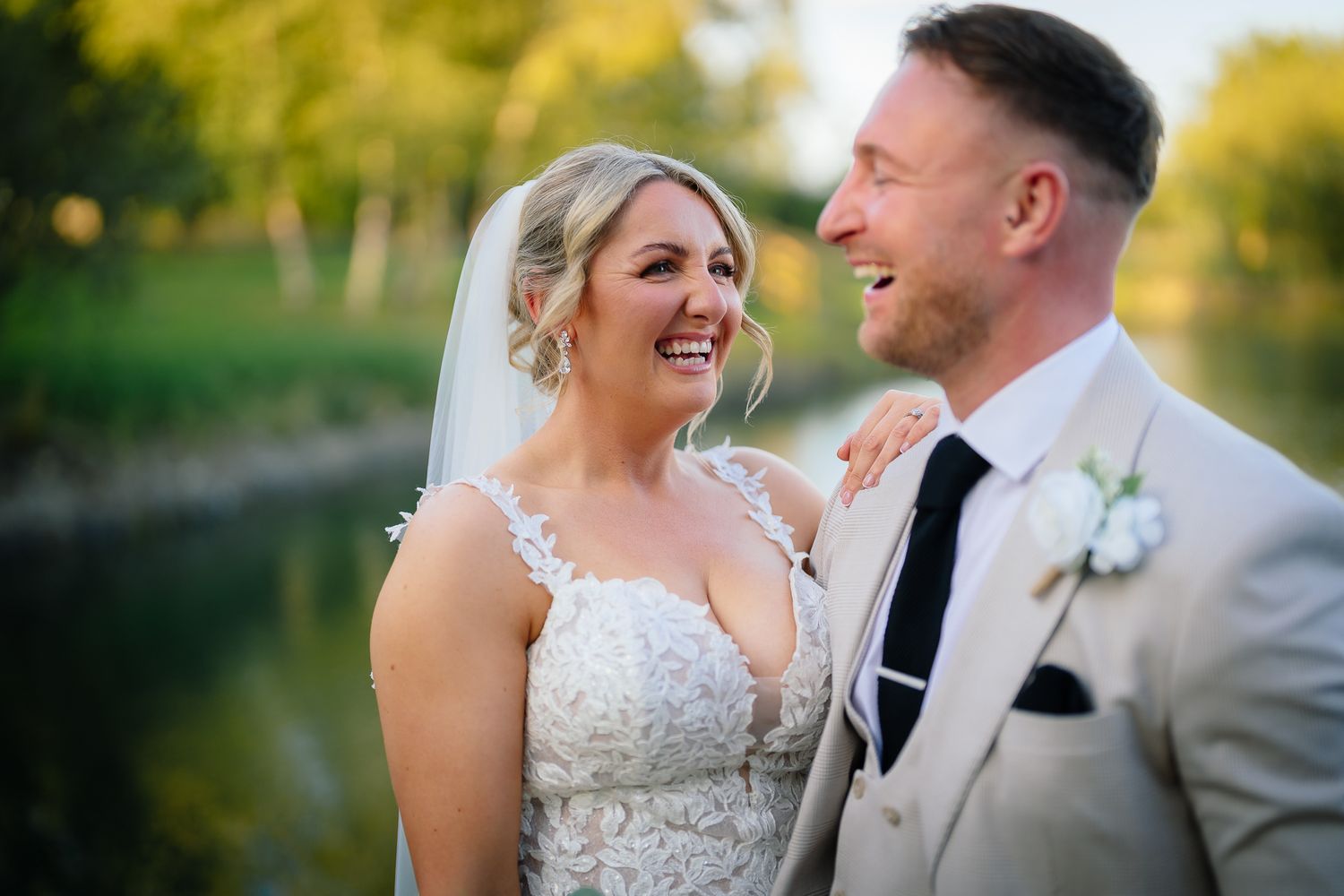 A couple shares joyful moments together outdoors during their wedding celebration at golden hour.