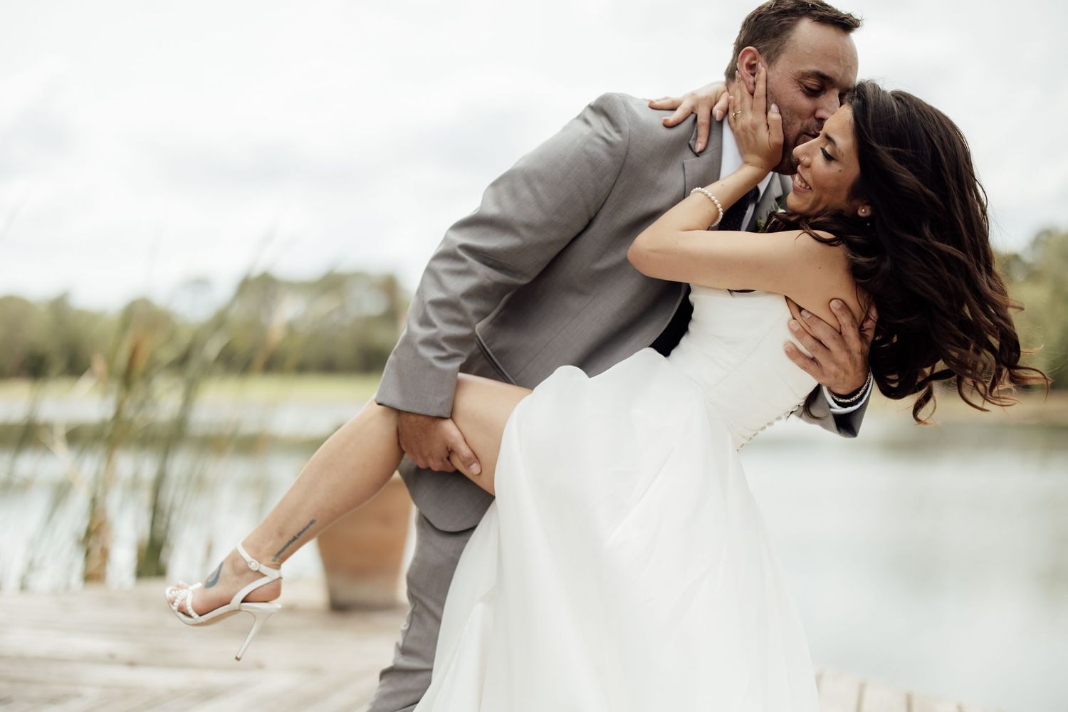An elegant winter wedding reception features romantic white floral decor and candlelight in a grand venue setting.
