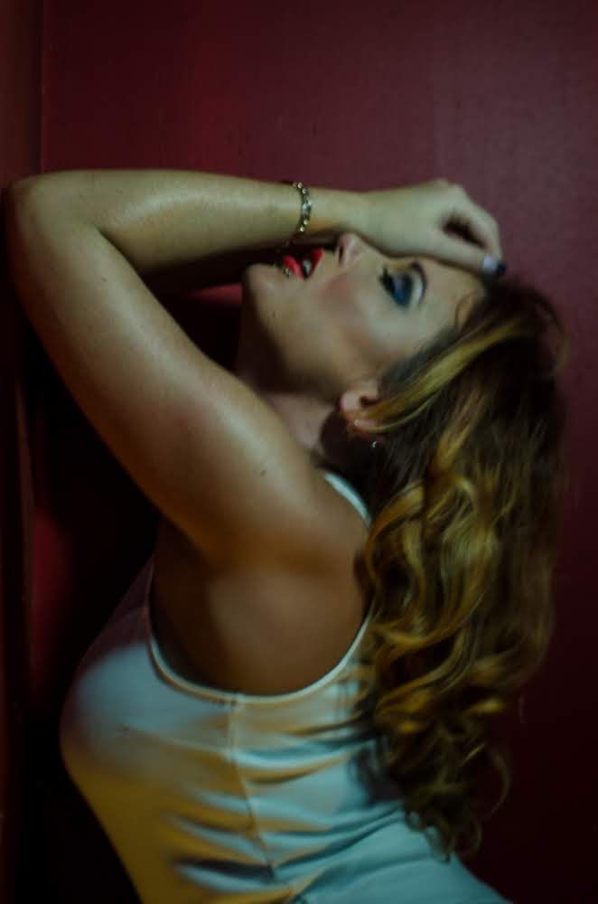 Artistic boudoir photo series showing poses in soft lighting against dark background.