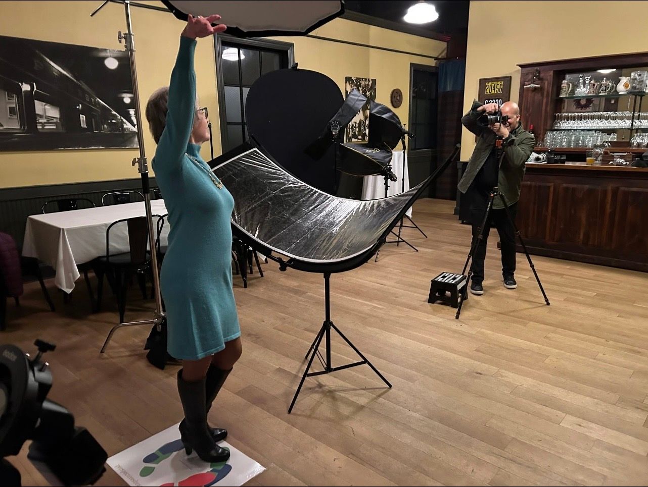 A professional headshot photographer capturing portraits at a corporate event.