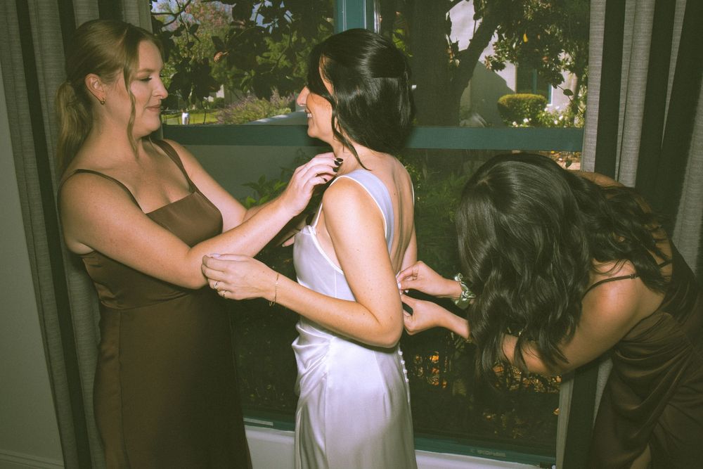 A group of people dancing together at an outdoor party in casual summer attire.