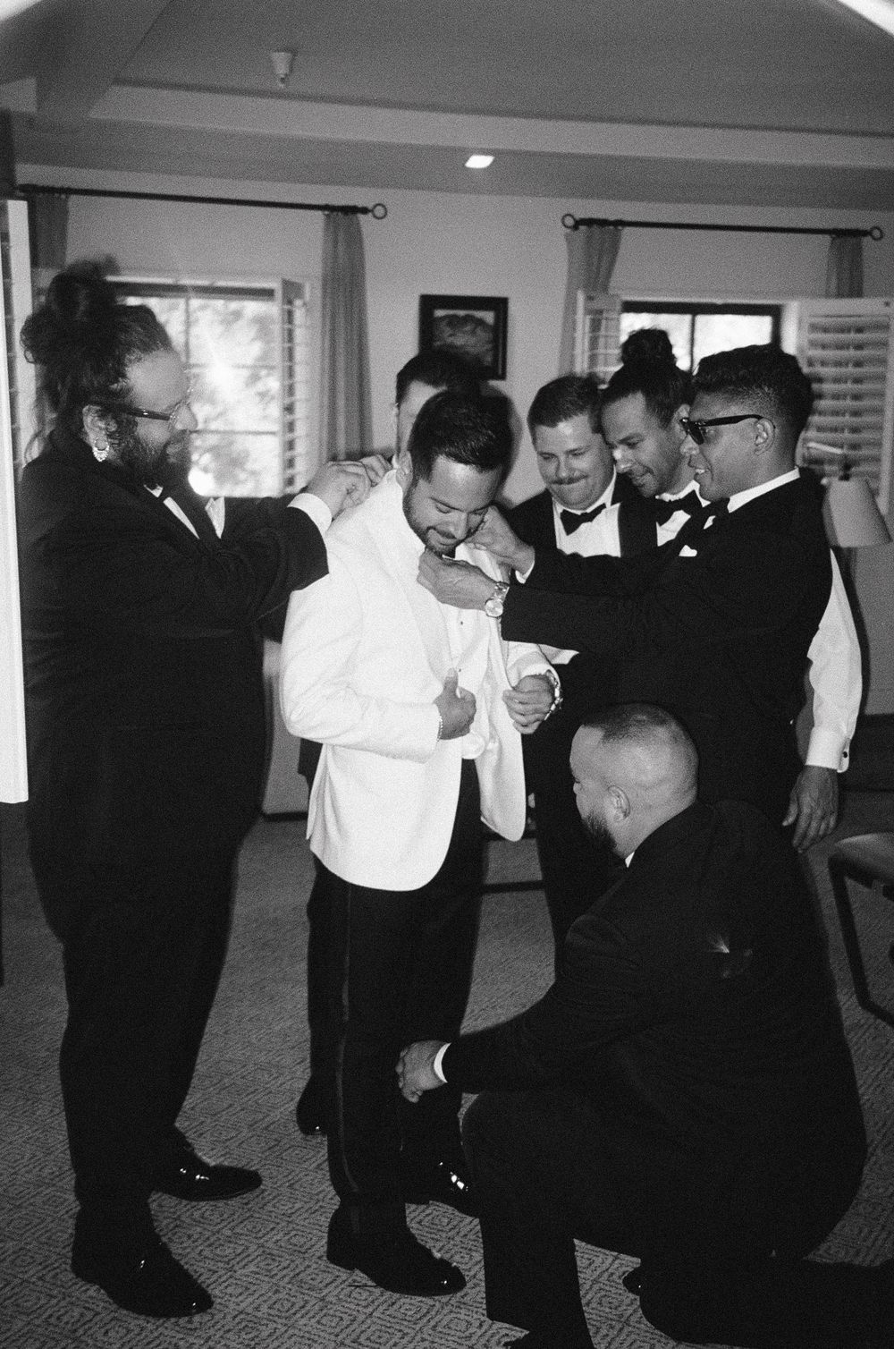A series of black and white photographs showing people dancing and socializing at what appears to be a formal event.