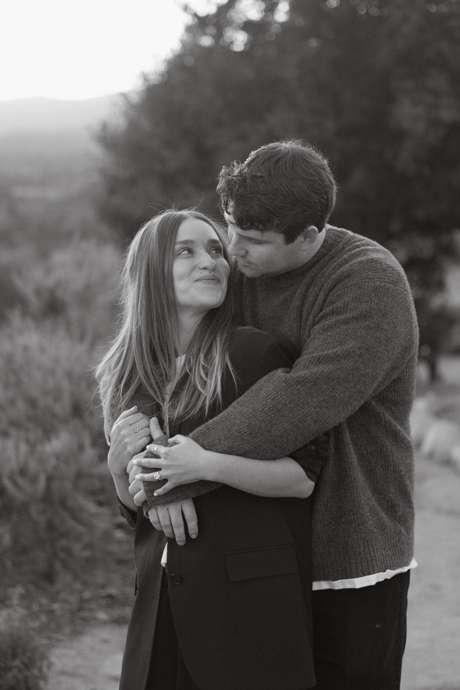 Black and white proposal photo in Ojai with a couple looking at each other