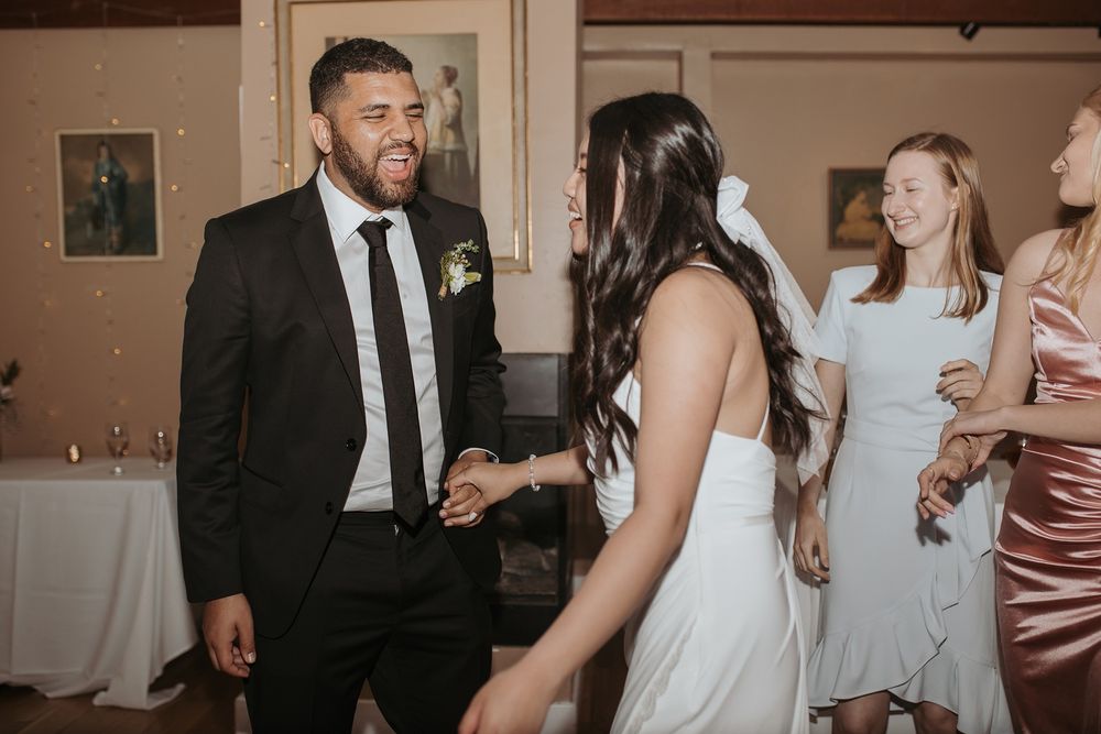 A couple shares a joyful moment on the dance floor at a wedding reception at Inn of the Seventh Ray in Topanga, California.
