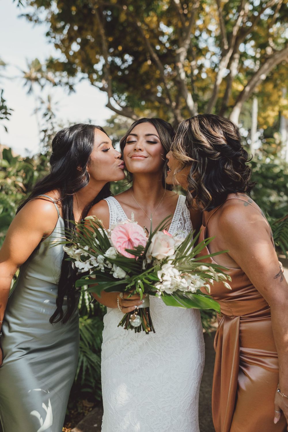 Bridesmaids in brown dresses share joyful moments with the bride in a white gown during an outdoor photo session.