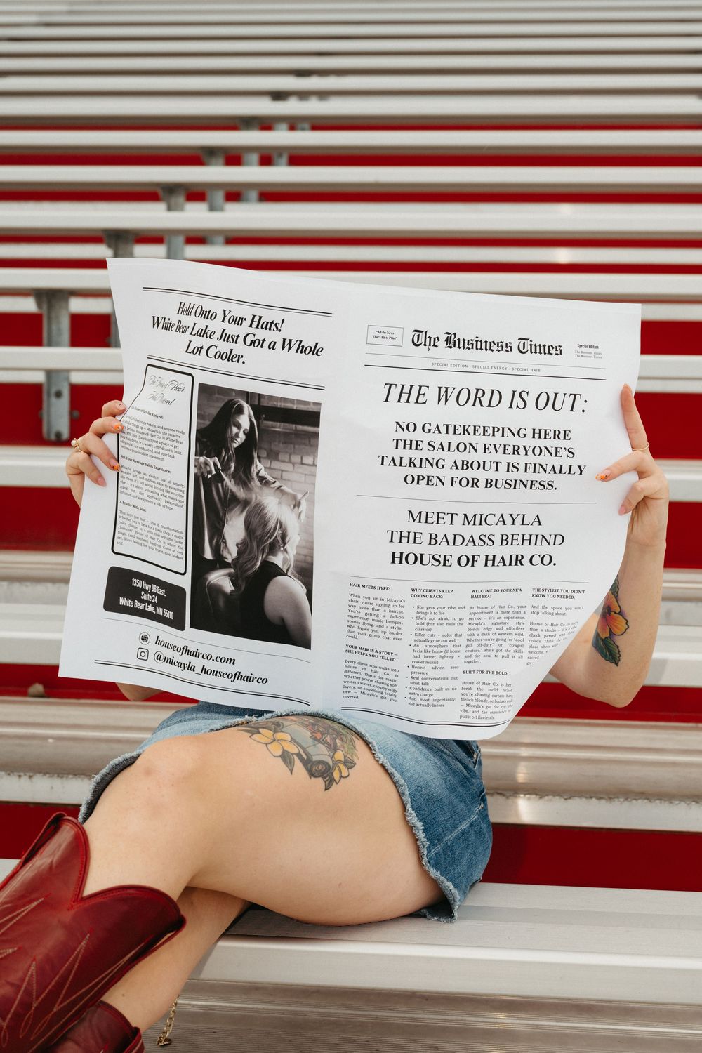 Series of newspaper headlines and clippings laid out on red and white striped surface.