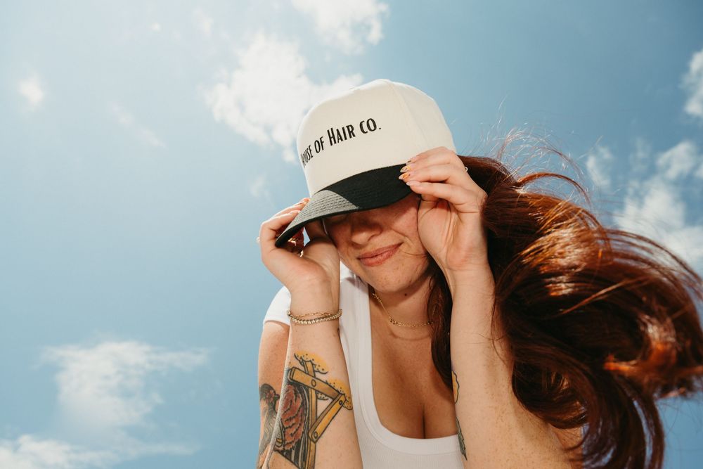 A series of six photos showing a person with long hair in various poses against a bright blue sky background.